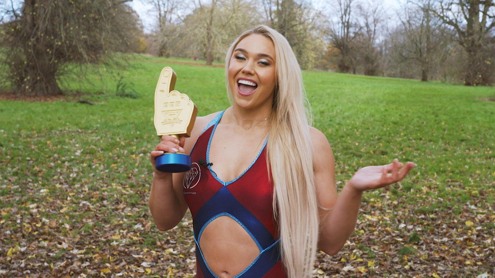 Gladiator Diamond holding a Glads of Honour award, shaped like a foam finger.