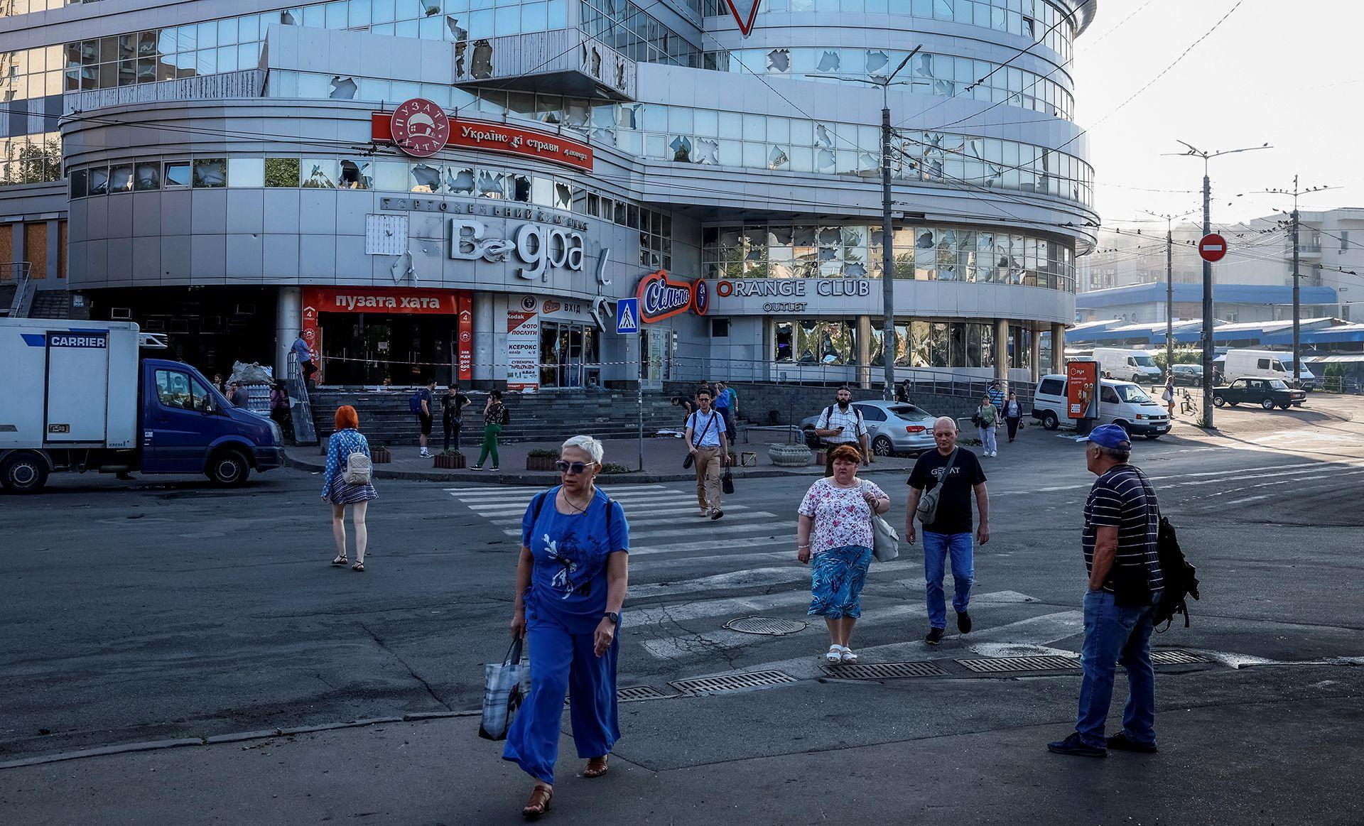 People walk across a zebra crossing outside a shopping mall in Kyiv on Thursday.