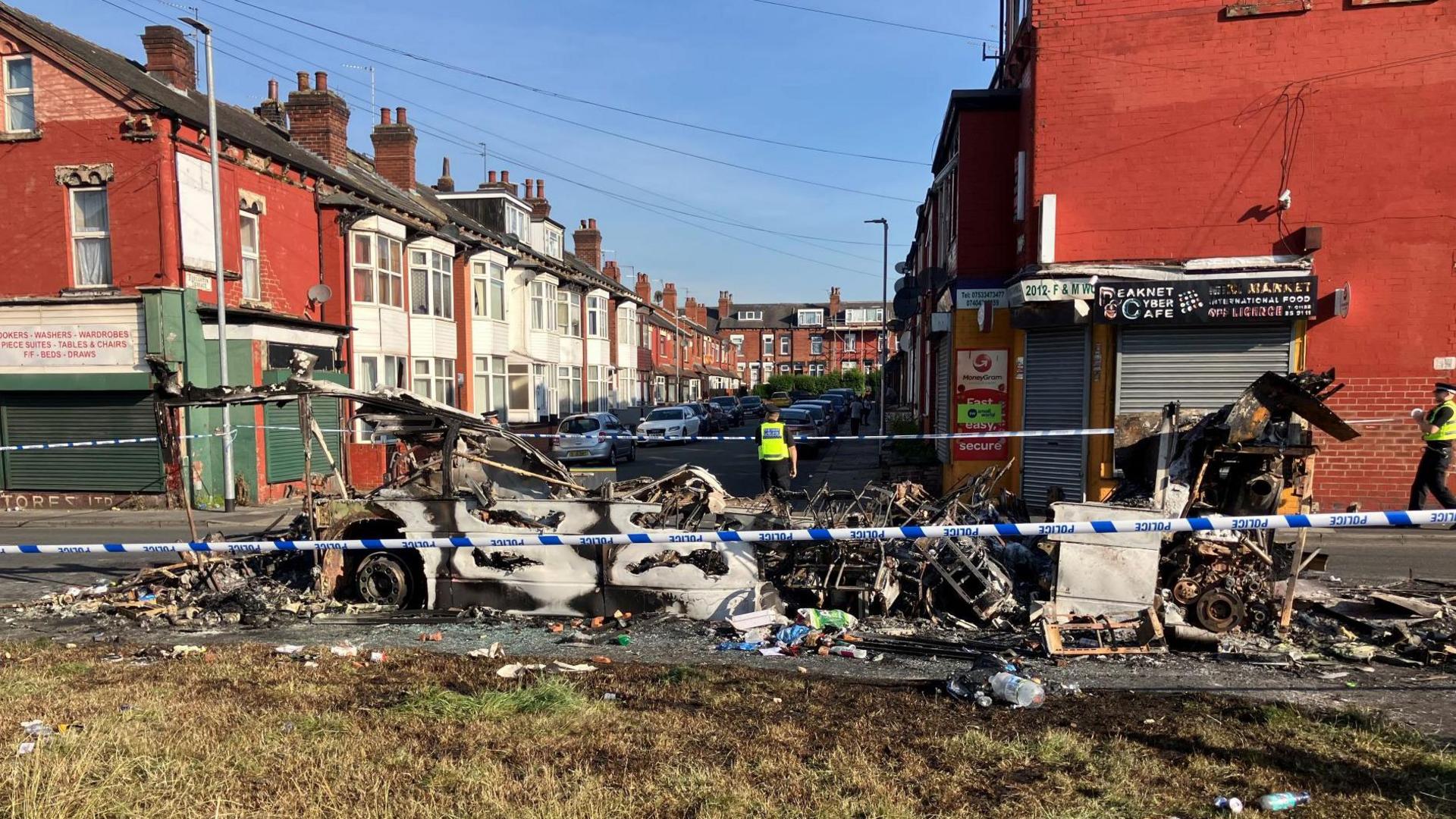 Charred remains of a burned out bus in Harehills, Leeds