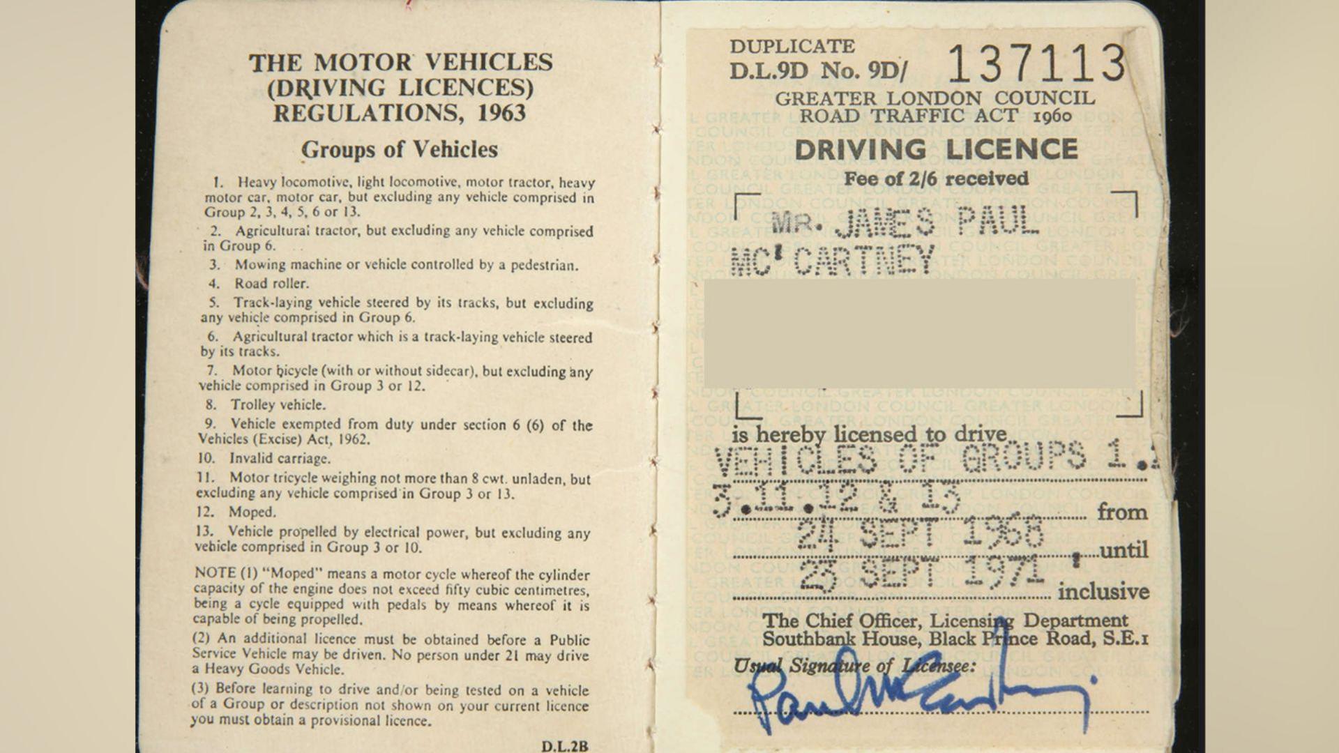 An old British driving licence. There is a signature signed with a blue felt pen.