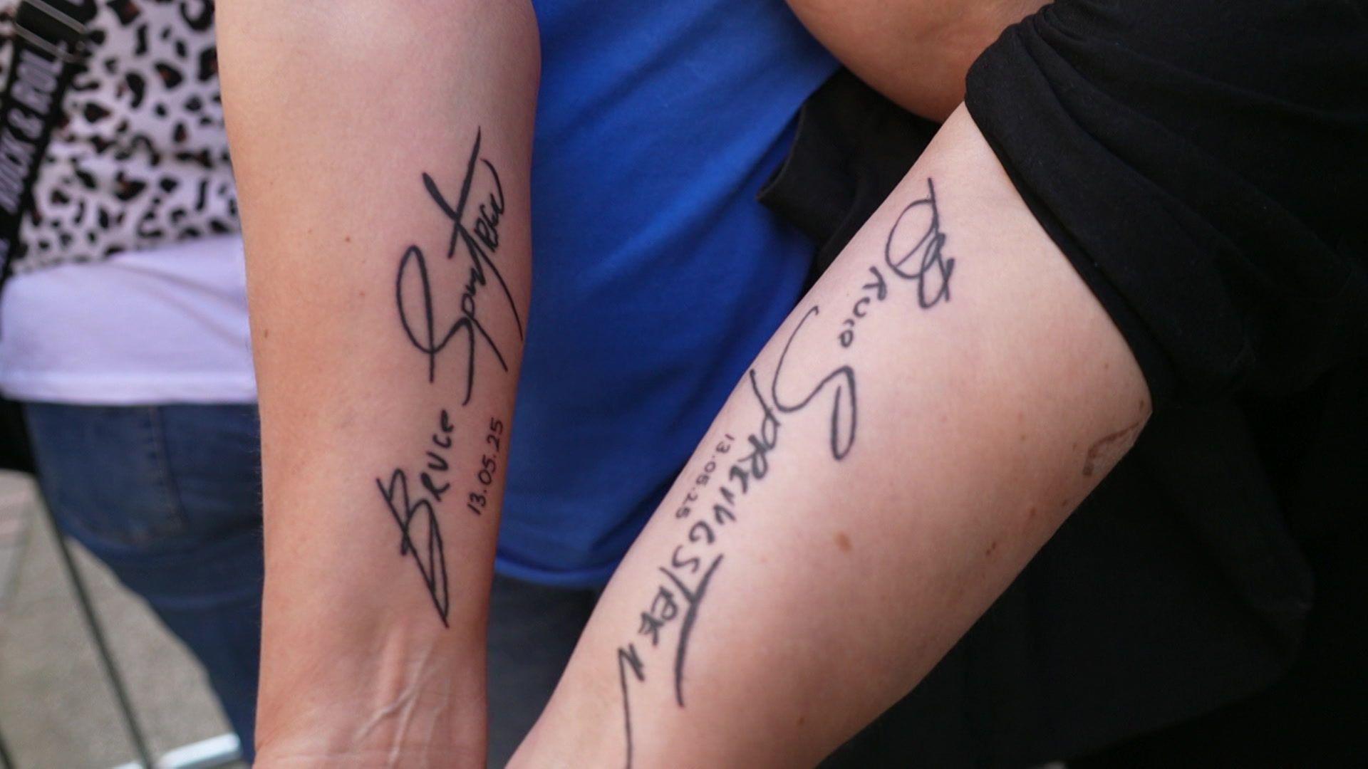 Two women's have the words "Bruce Springsteen" in cursive handwriting and the date "13-05-25" underneath has been tattooed onto them in black ink.