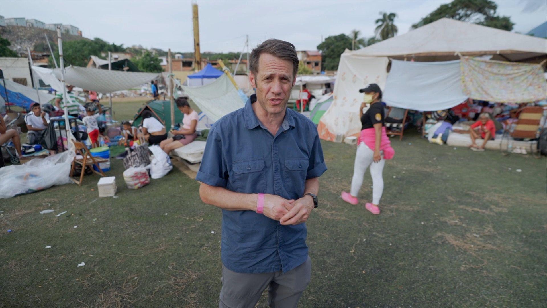 Will Grant in blue shirt in a campsite