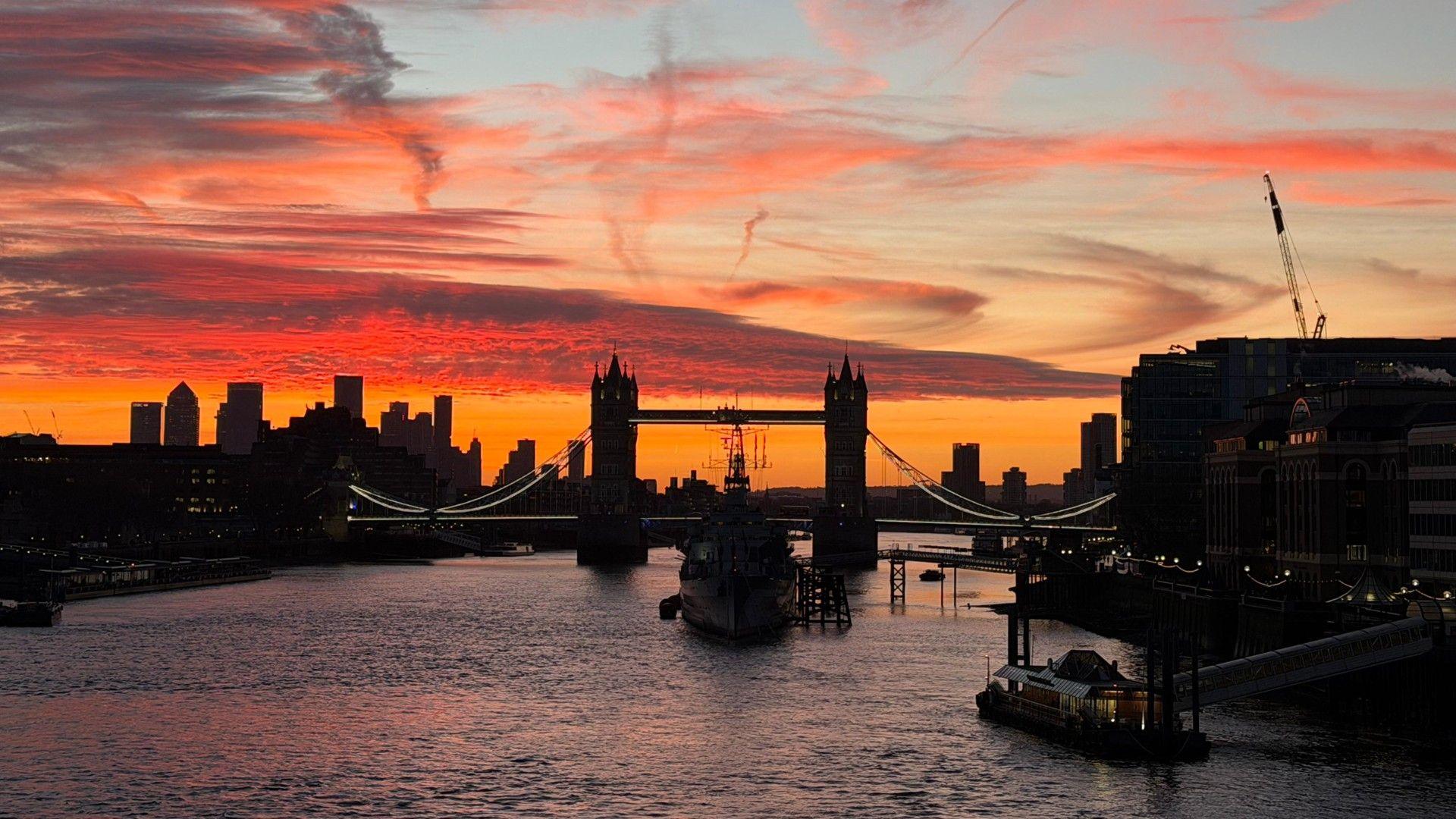 Blood red sunset over the Thames behind Tower Bridge in central London