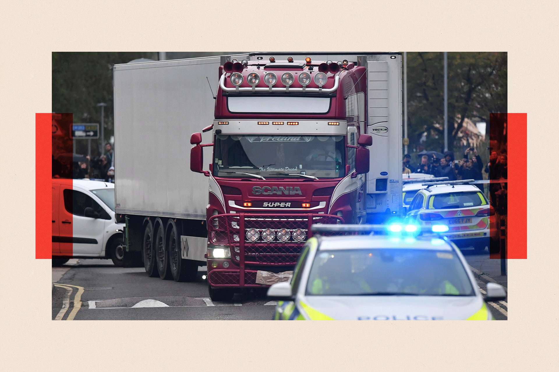 Police officers drive escort the lorry in which 39 dead bodies were discovered 