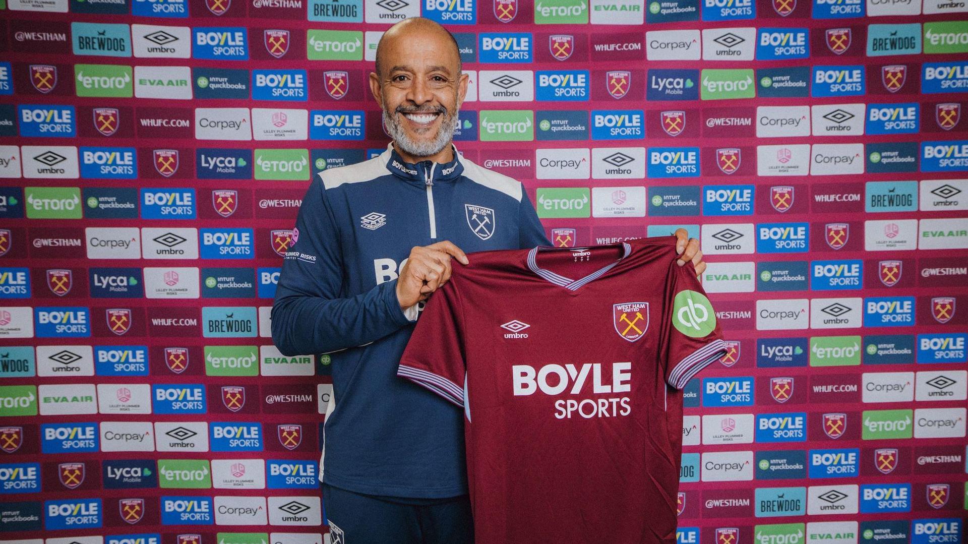 Nuno Espirito Santo holds up a West Ham shirt after being appointed as head coach