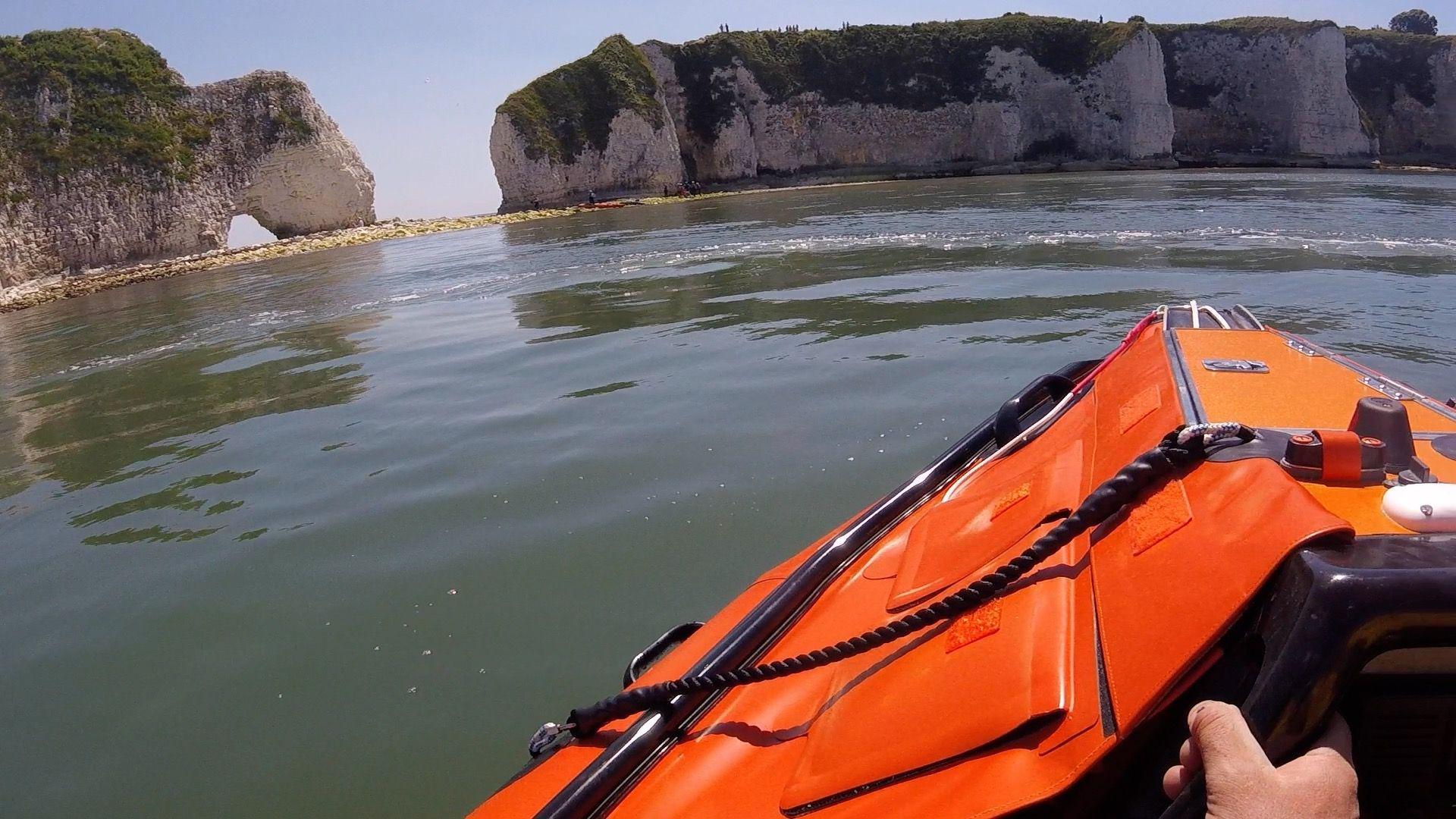 Cliffs in the background with front of lifeboat in bottom right hand corner