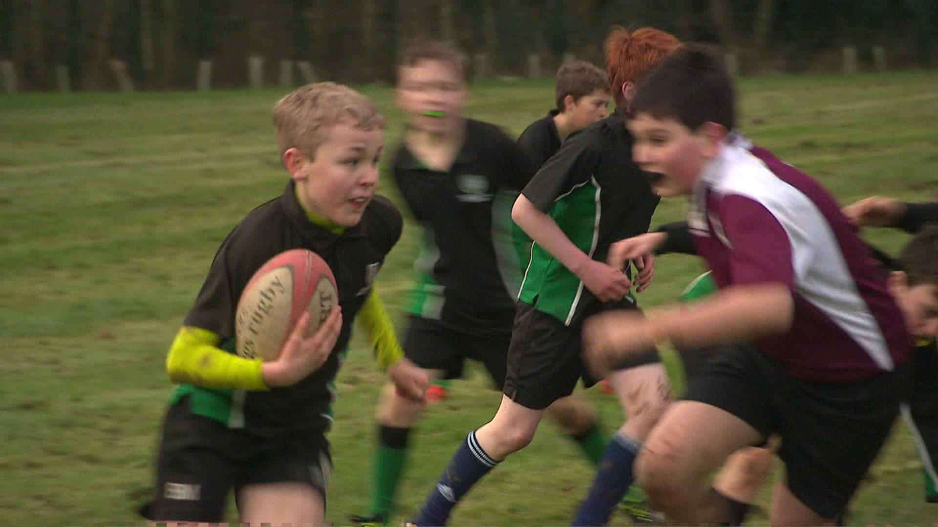 Schoolchildren playing rugby