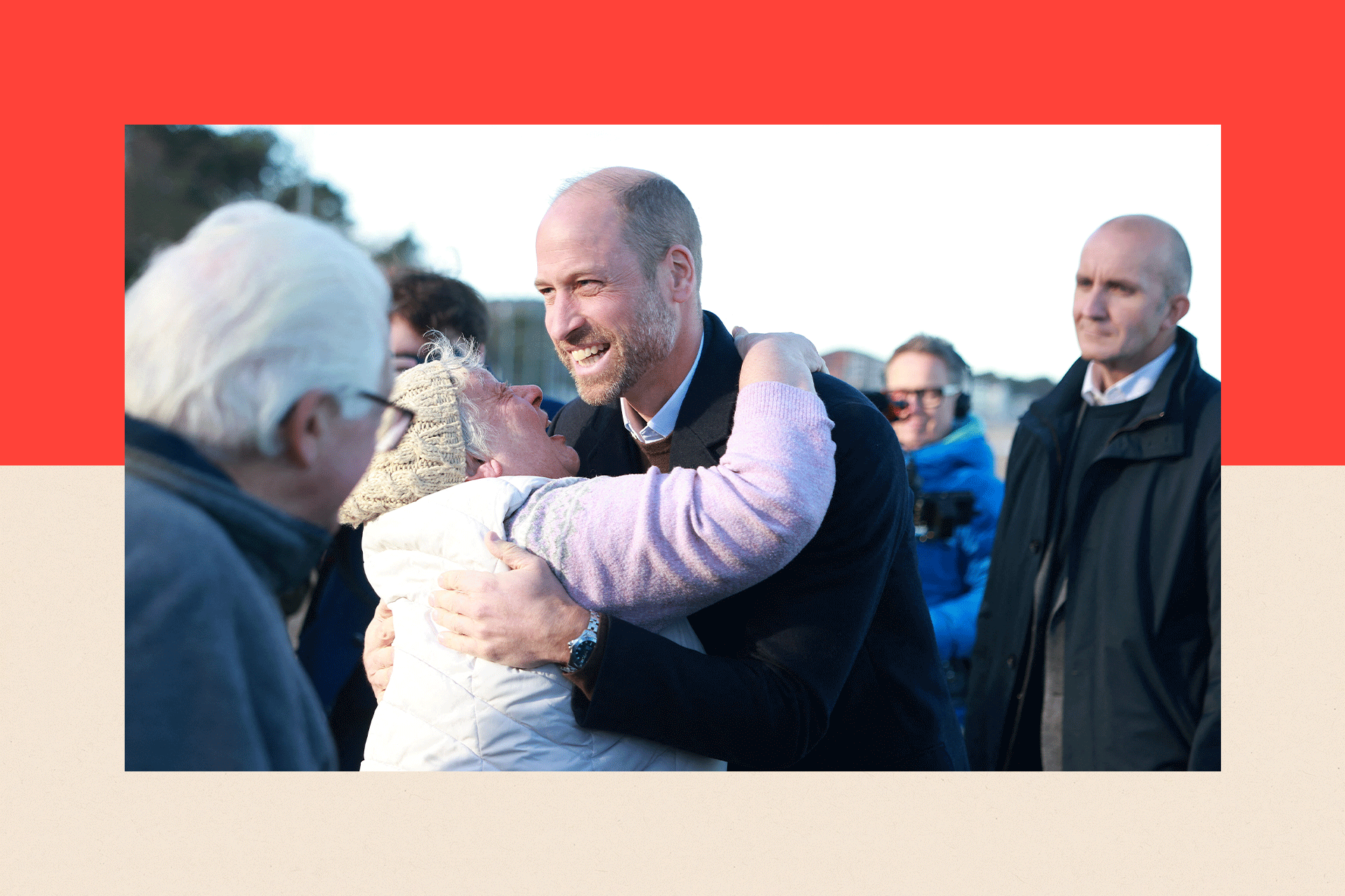 Prince of Wales hugs a well-wisher during a visit to the beach at Colwyn Bay, Wales