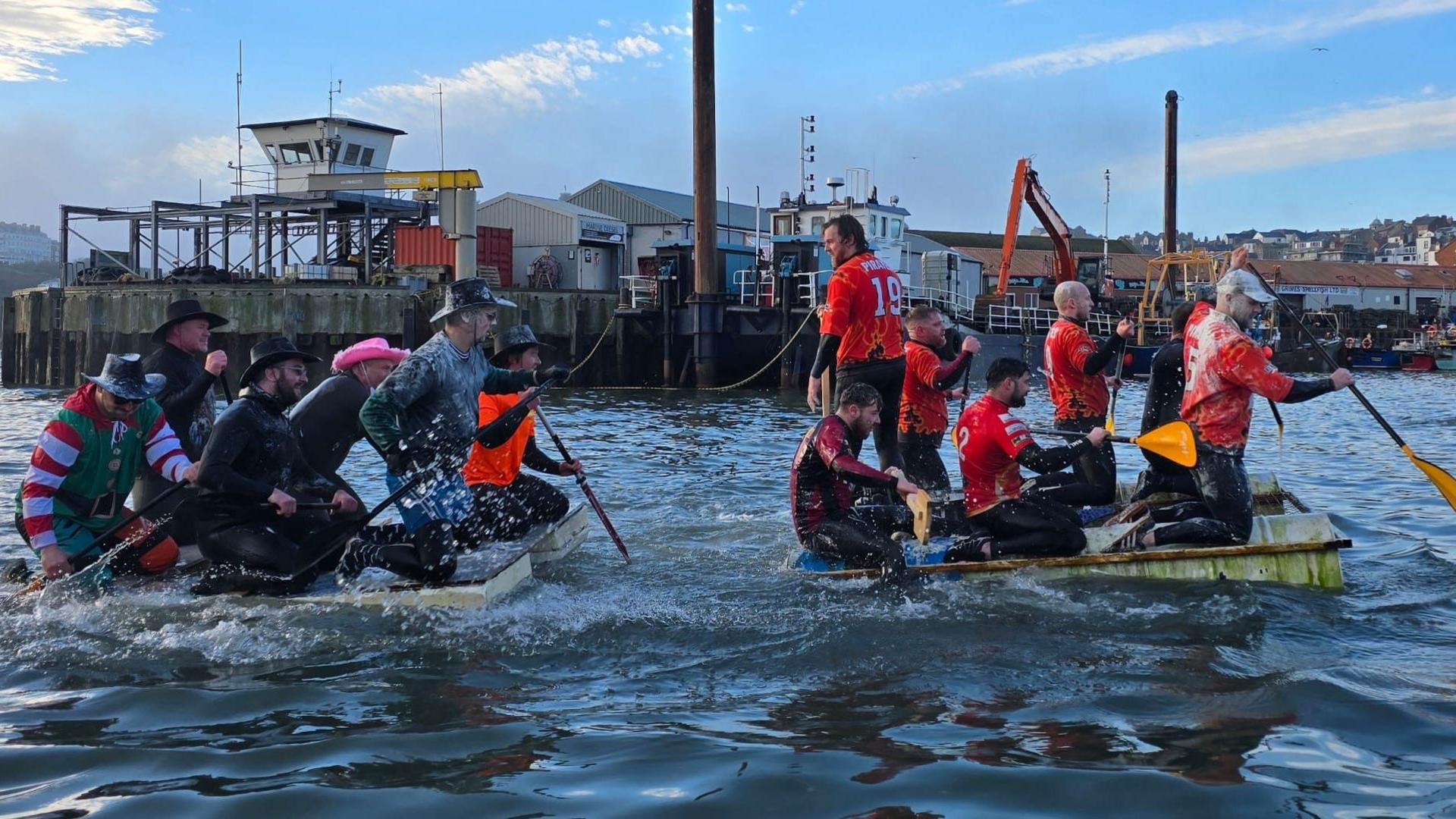 Two rafts with several crew members on board racing each other at sea in Scarborough  