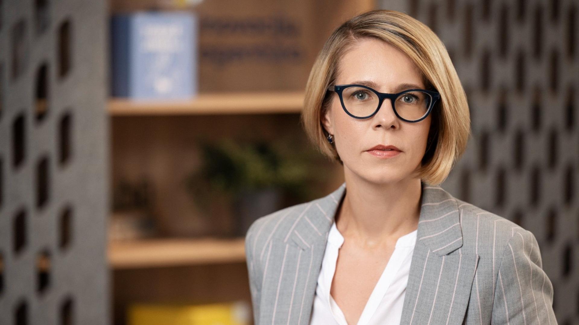 Blonde haired Eglė Elena Šataitė in a pin-striped jacket