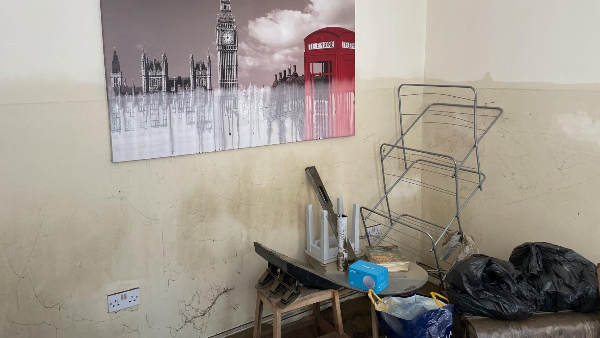 Water mark seen in a home that was flooded - that has also affected a painting of Westminster / Houses of Parliament and River Thames / London iconography