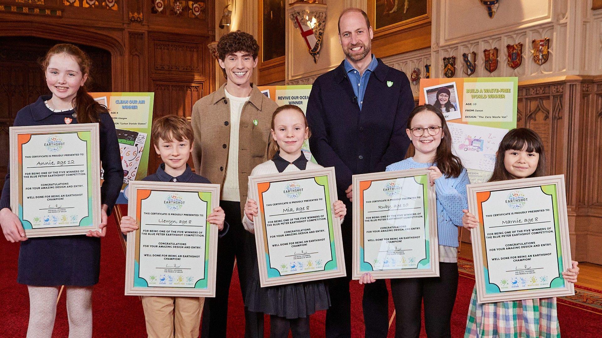 Blue Peter Earthshot competition winners with Blue Peter presenter Joel Mawhinney (left) and Prince William (right). 