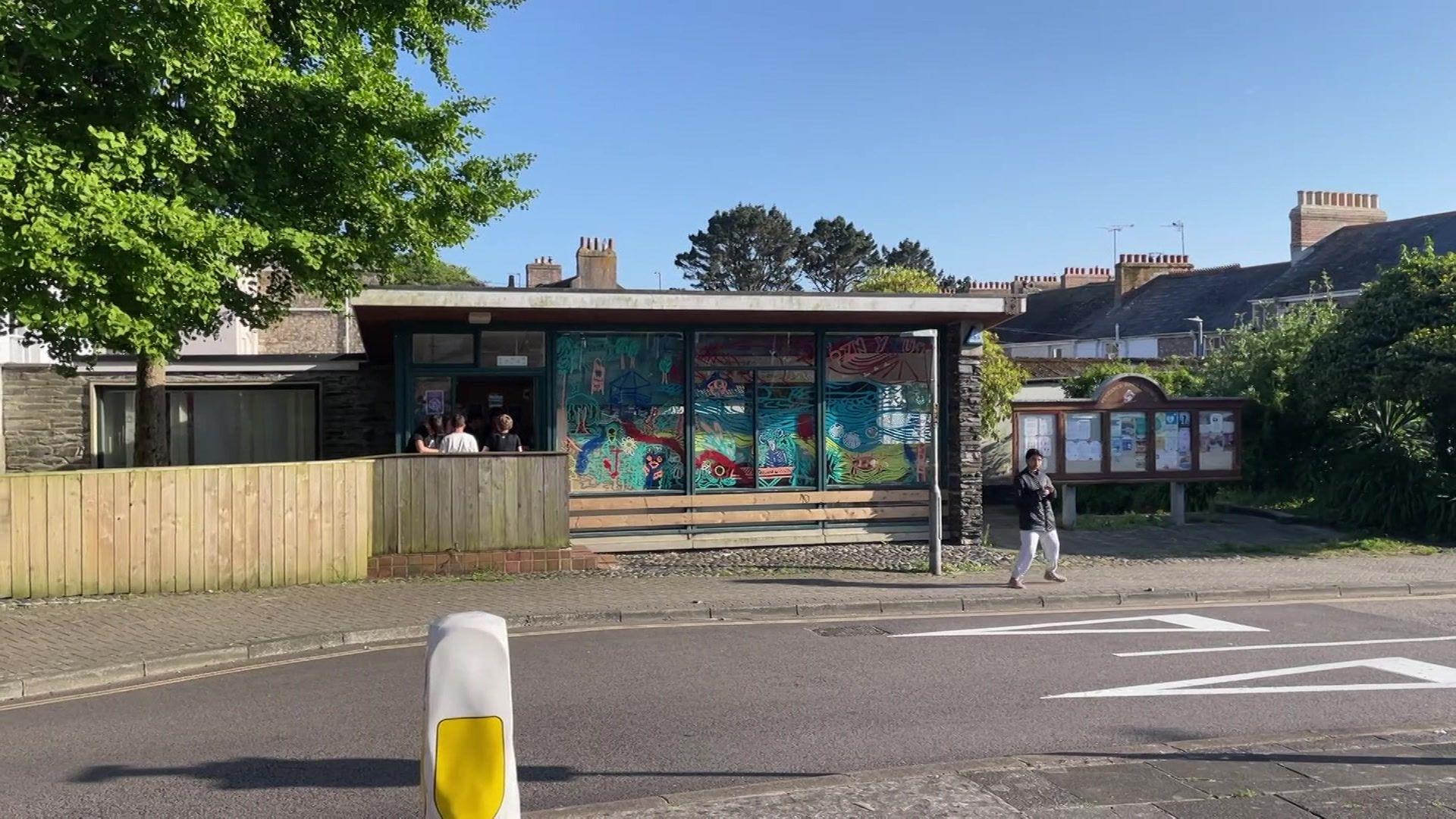 A building in Penzance. It's glass front is painted with bright murals