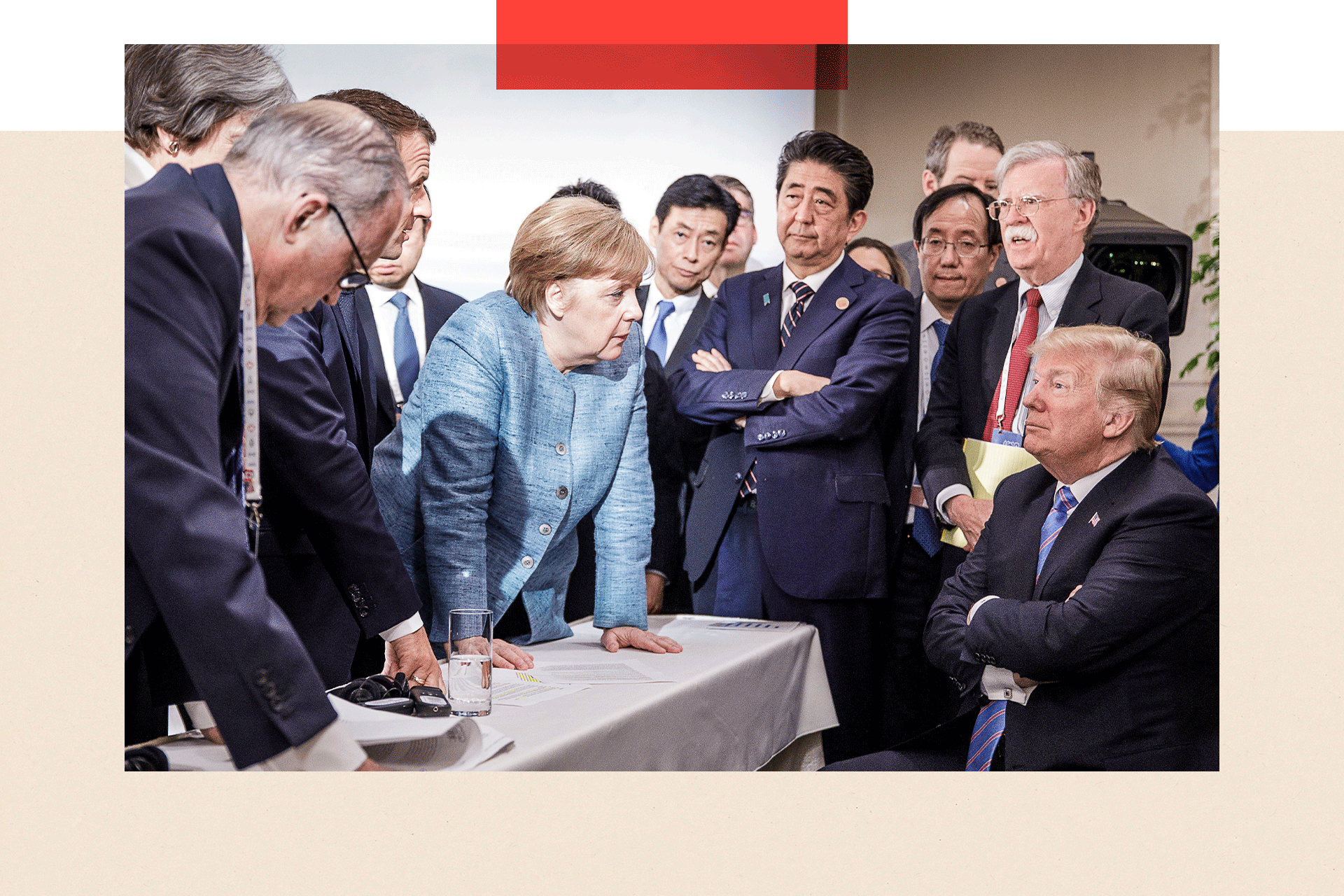 Former German Chancellor Angela Merkel deliberates with Donald Trump during the G7 summit, as he sit with his arms folded