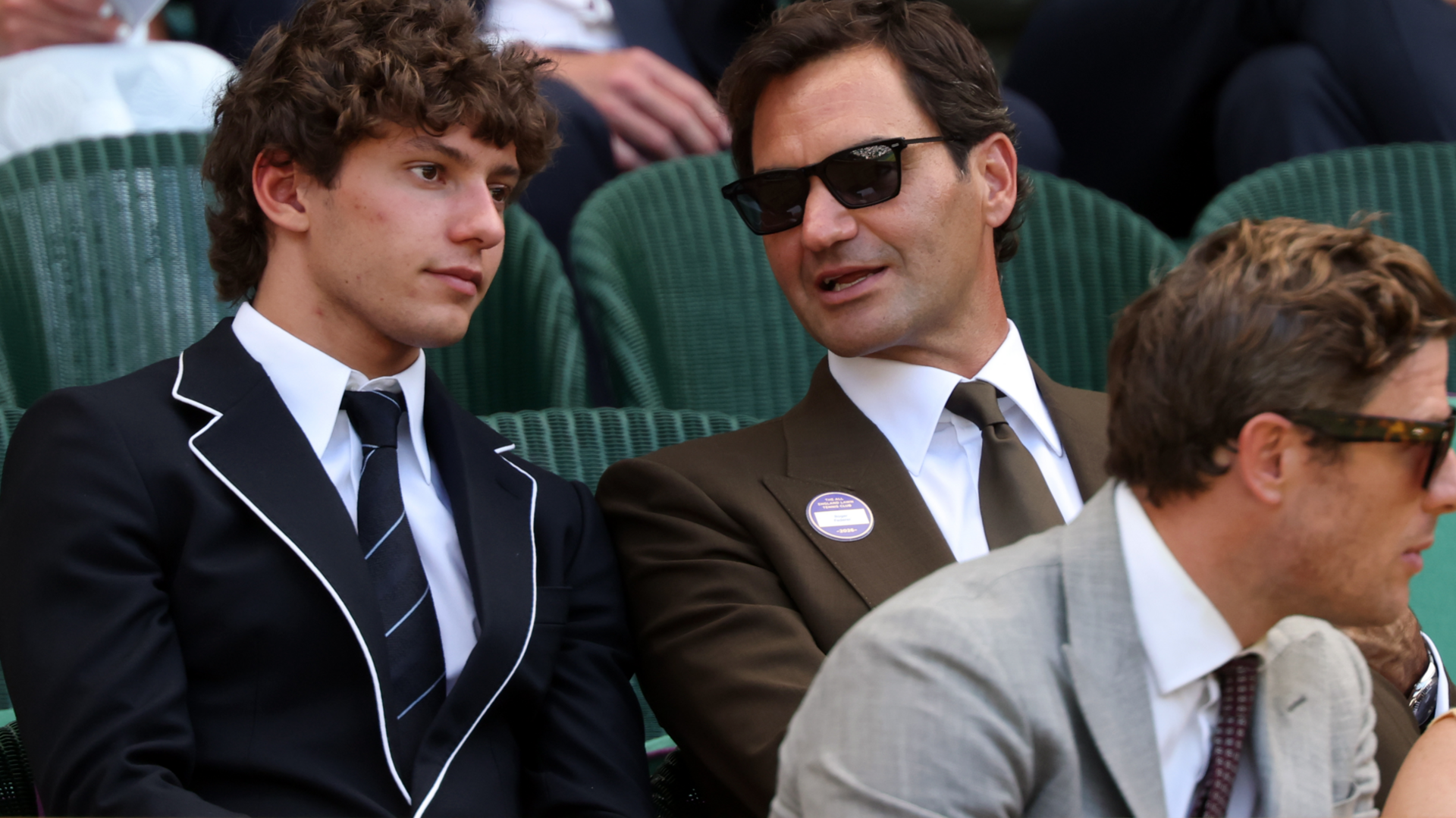 Kimi Antonelli listens to Roger Federer
