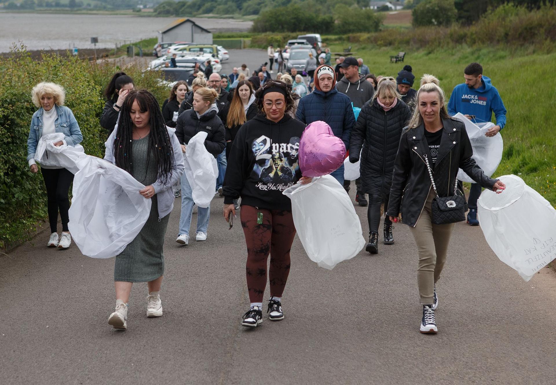 Kathryn Patron vigil friends walking carrying lanterns