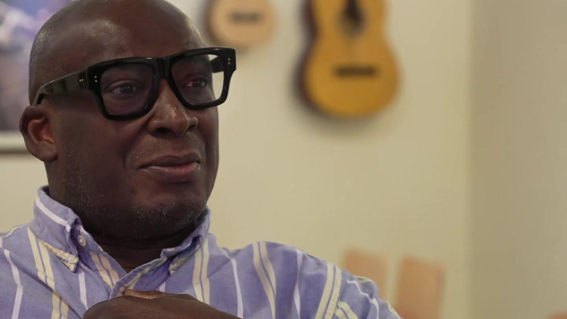 Mr Geohagen in a blue and white stripe shirt. He has black framed glasses.