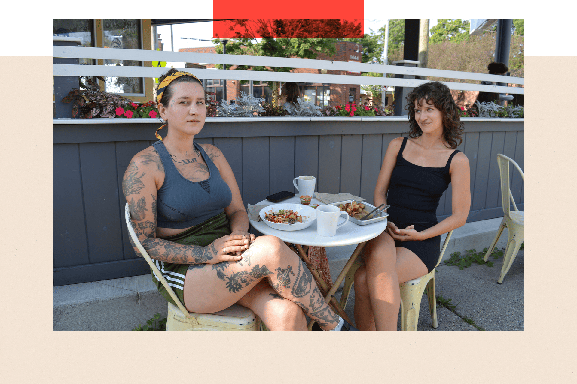 Two women sitting outside a cafe