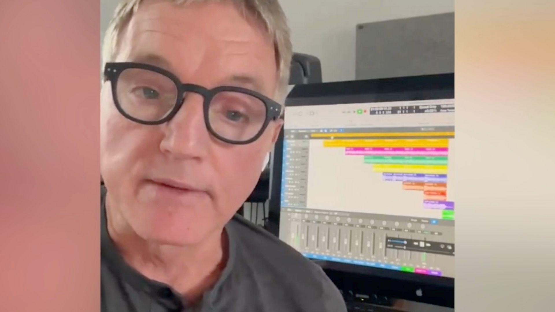 David Lowe sitting in front of a computer showing music tracks