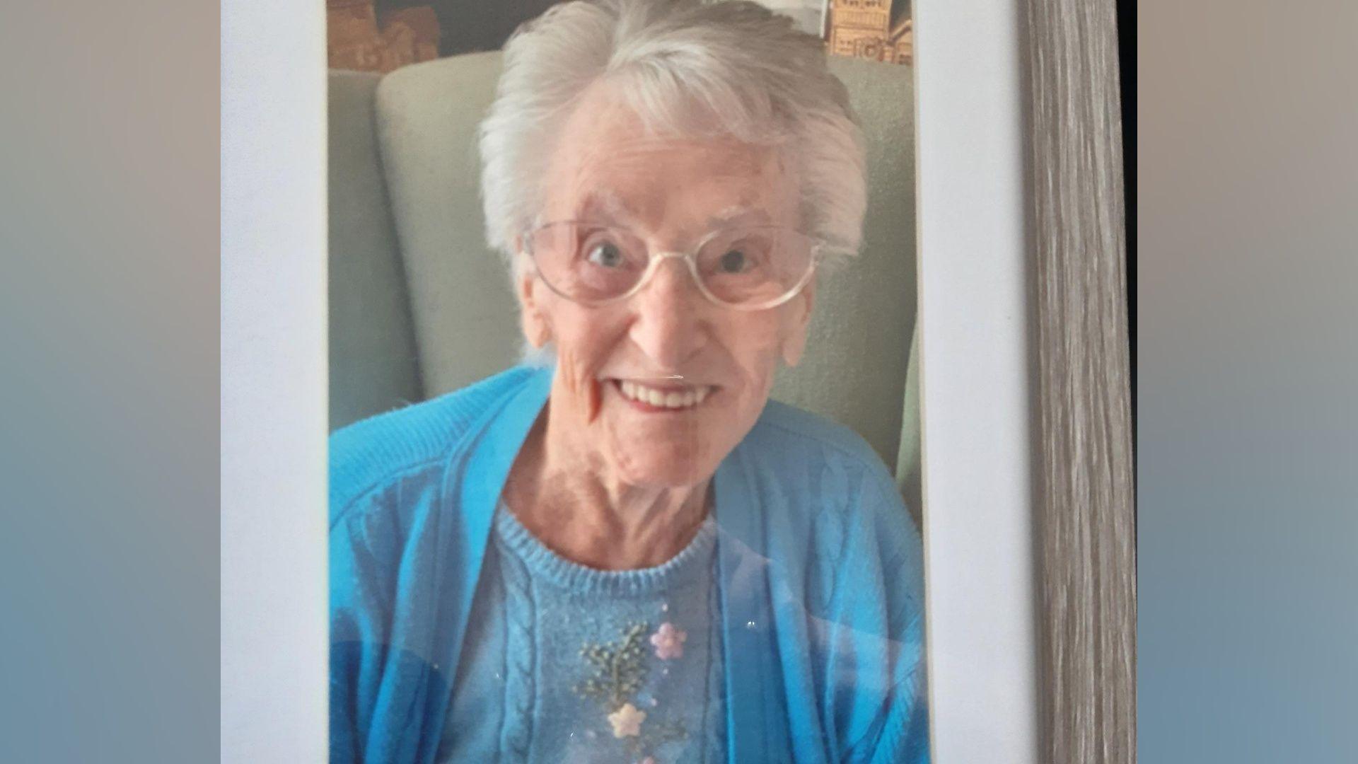 Joyce Moulton pictured sitting connected  a seat  smiling. She has grey hairsbreadth  and is wearing a bluish  cardigan and glasses.