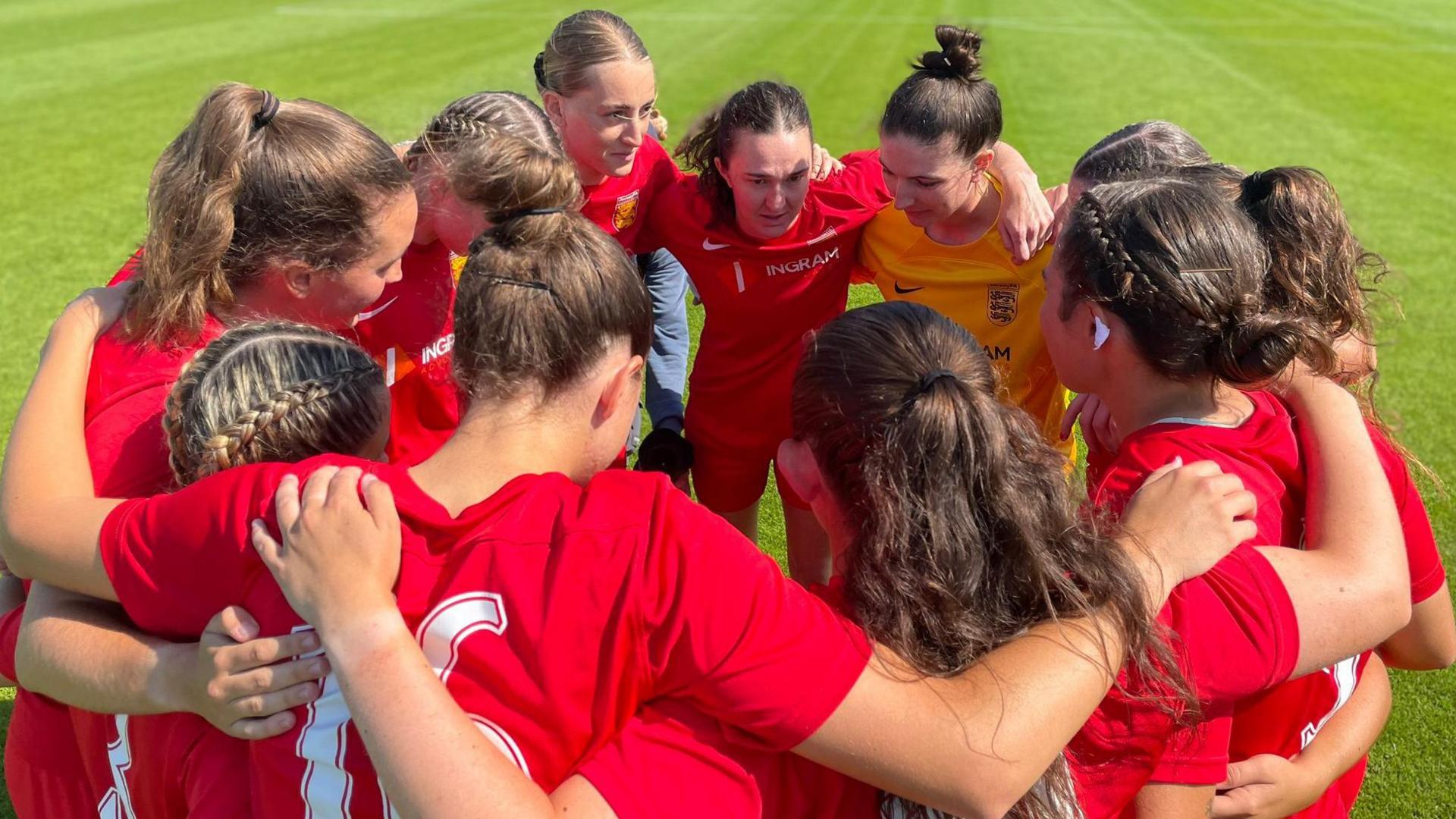 Jersey women in a huddle ahead of their game with Shetland