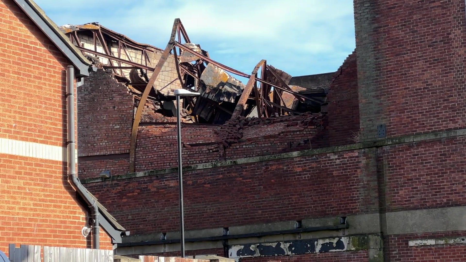 The roof of the brick building, which housed the former cinema, has collapsed exposing metal beams.