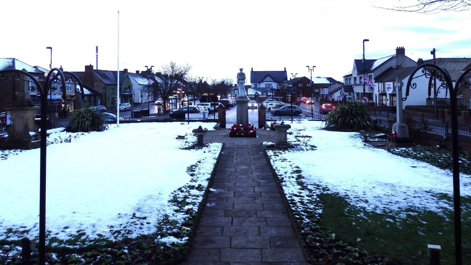 The square outside of the Ferryhill Town Council building is carpeted in snow.
