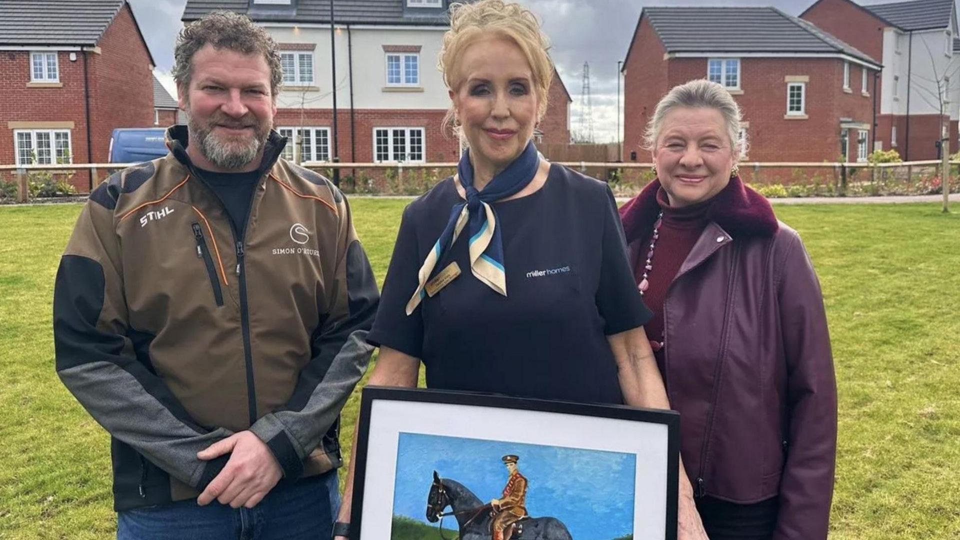 Artist Simon O'Rourke, Debbie Vivis from Miller Homes and local historian, Heather Charles