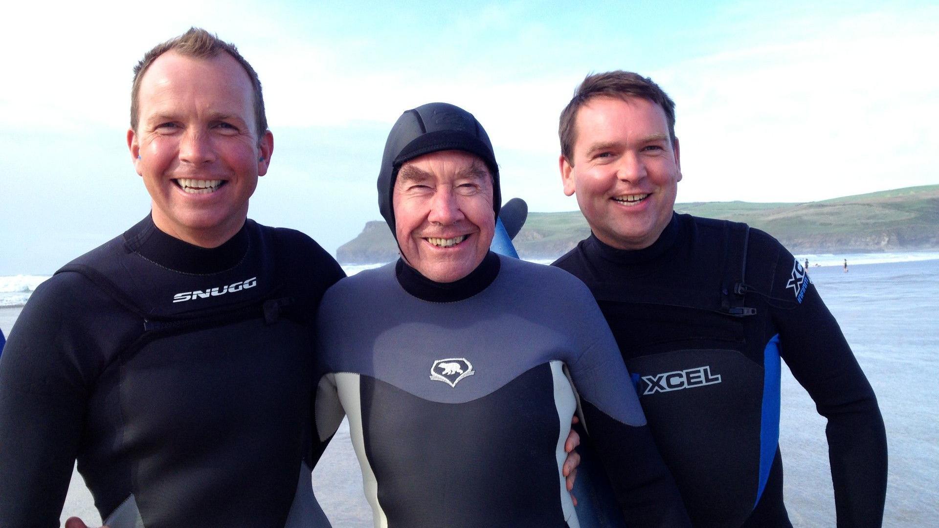 Sir Terence (middle) with his sons either side of him. They are all wearing wet suits.