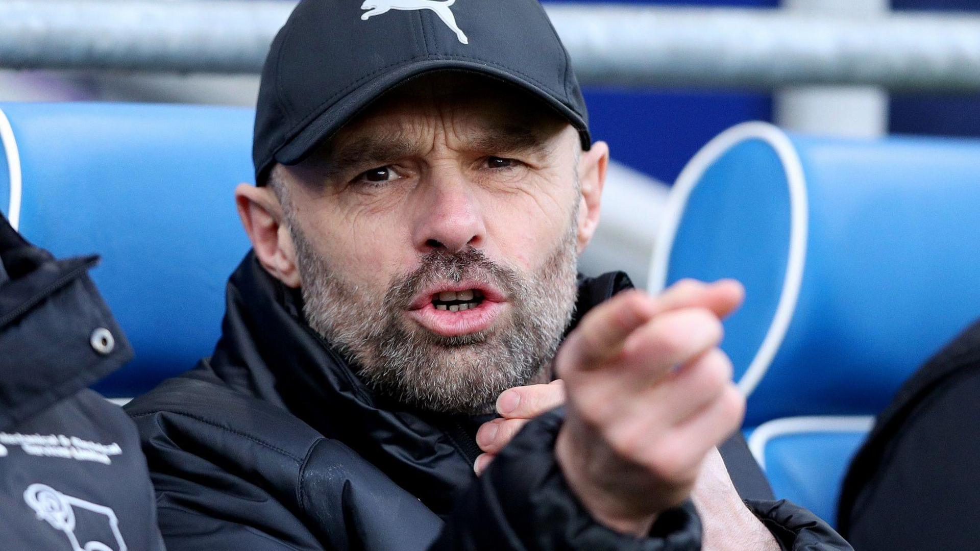 Paul Warne points and chat while in Derby County's dugout