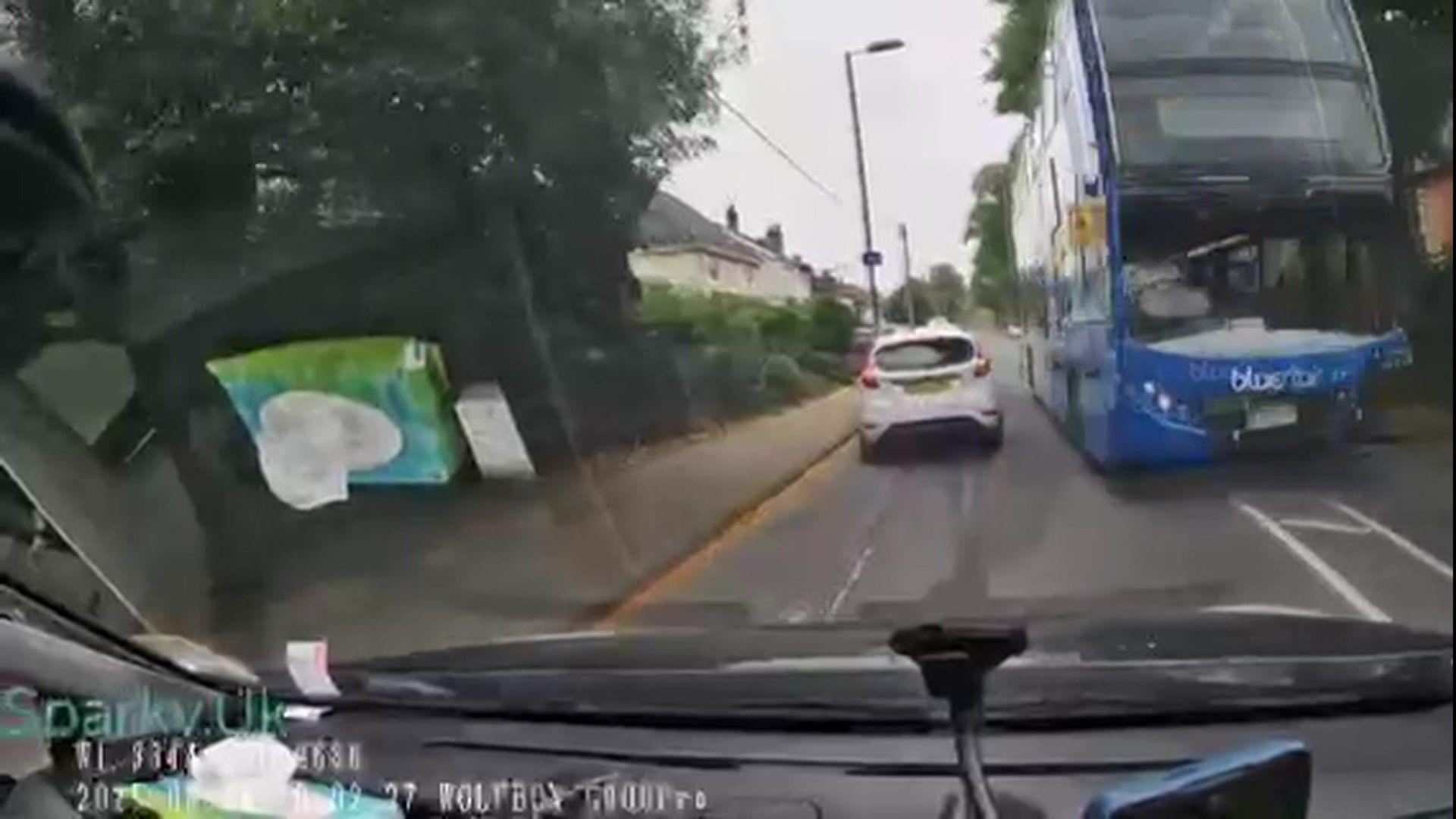 Bus appears coming towards middle of the road towards oncoming traffic