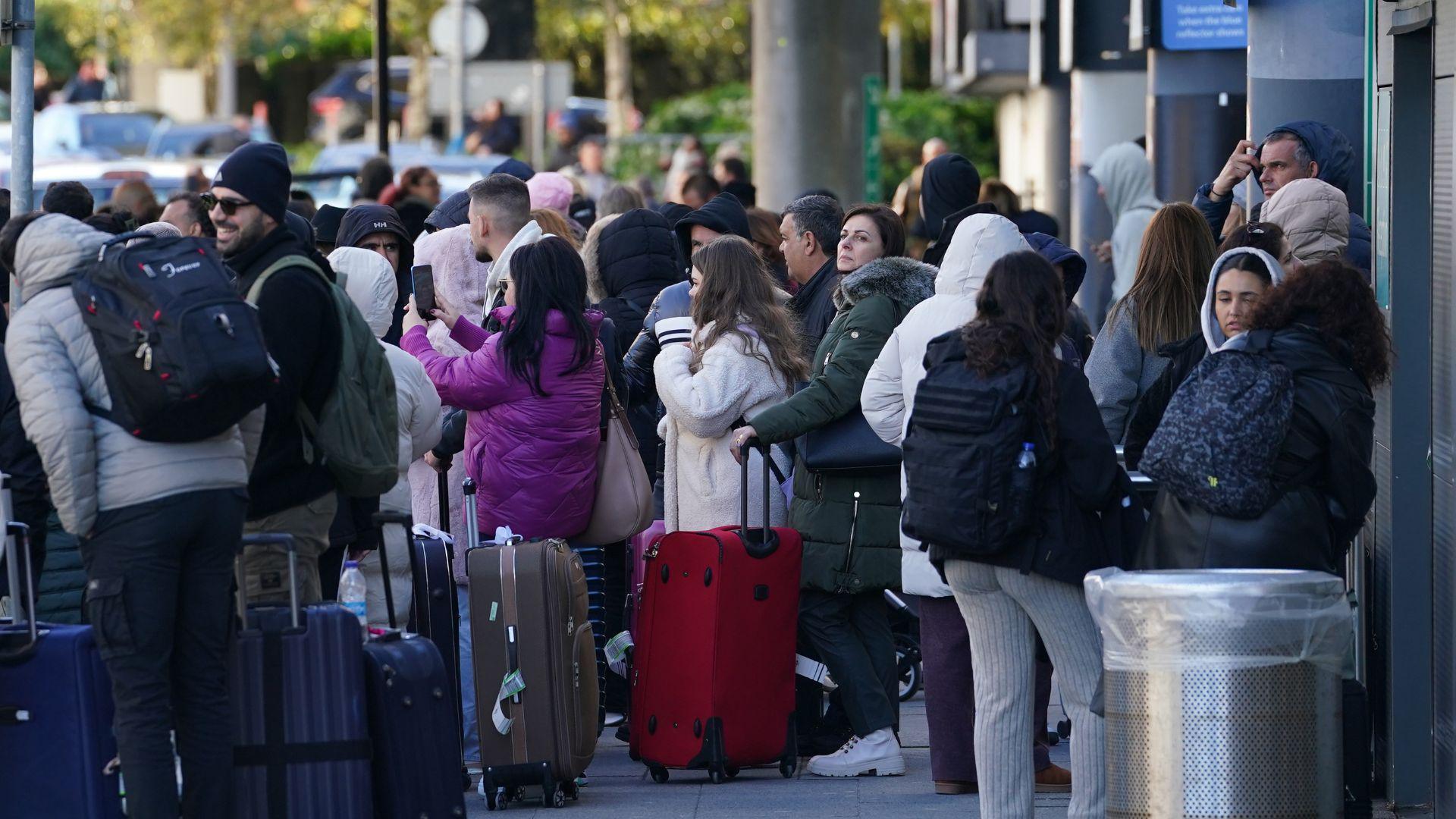 Dozens of people gathered outside an airport terminal building