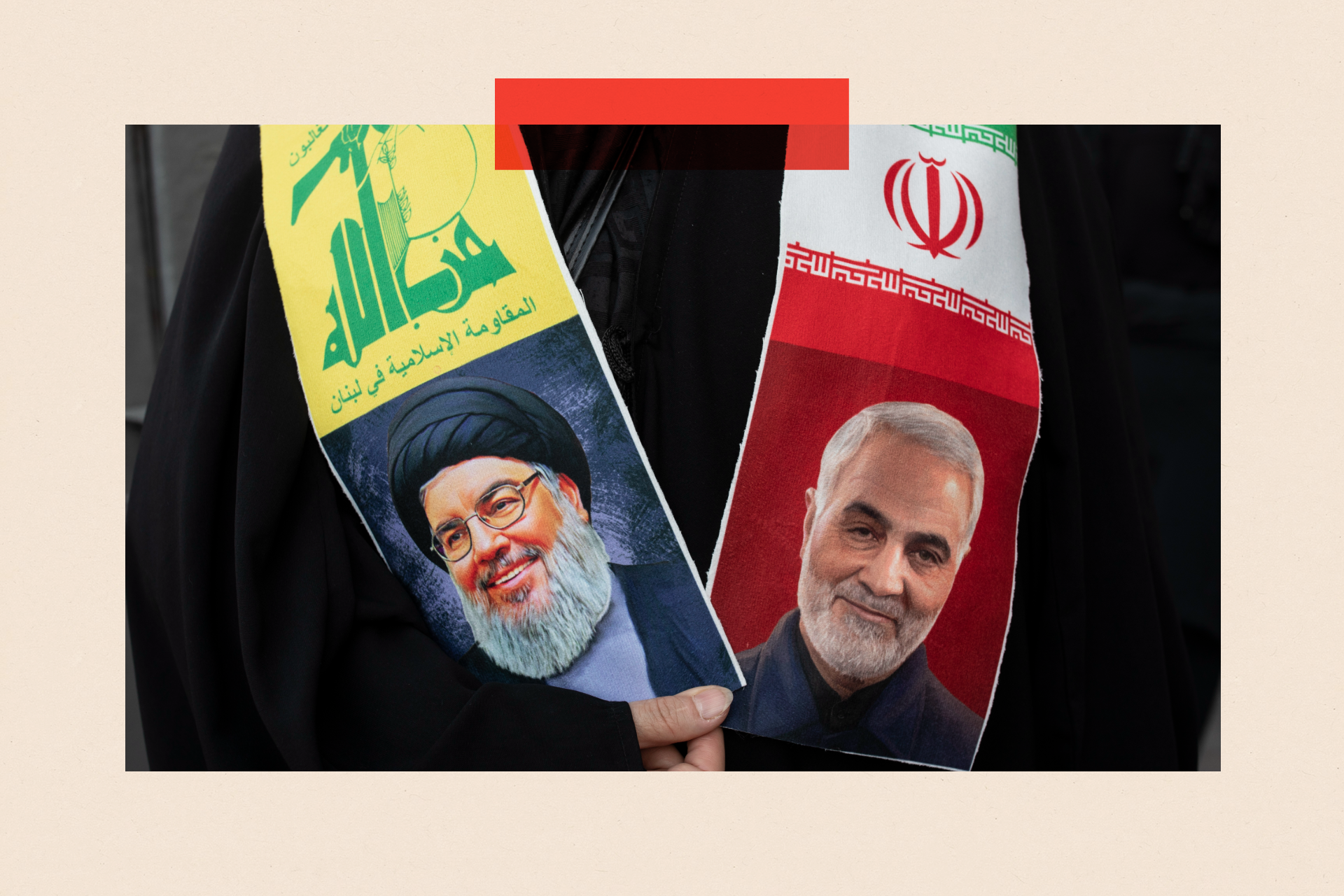 An Iranian woman carries a shawl with pictures of Hezbollah leader Hassan Nasrallah, left, and IRGC Quds Force commander Qassem Soleimani hanging around her neck during a march in Tehran.