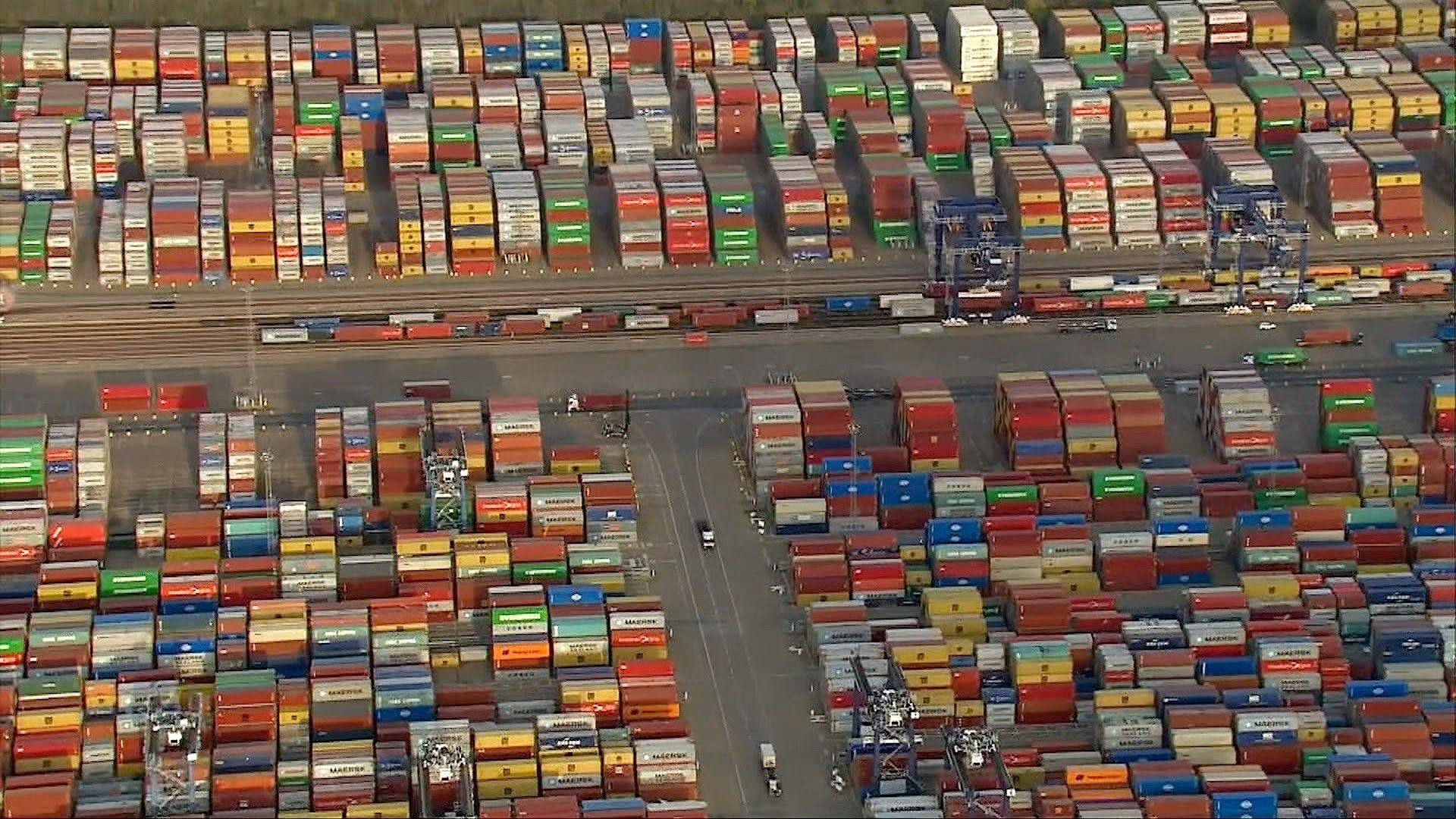 An aerial view of lines of multi-coloured containers at the Port of Felixstowe with cars driving between them