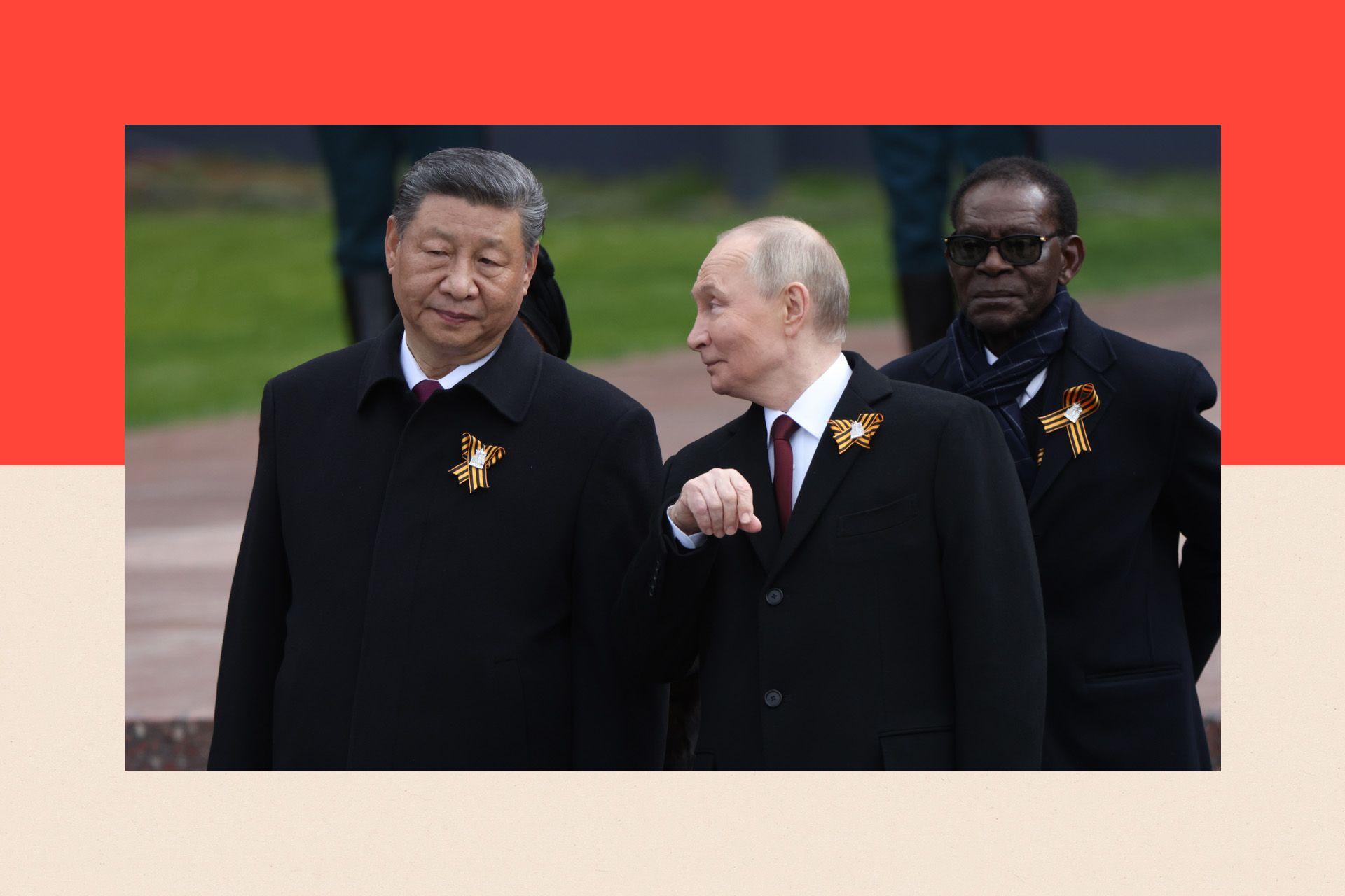 Russian President Vladimir Putin talks to Chinese President Xi Jinping