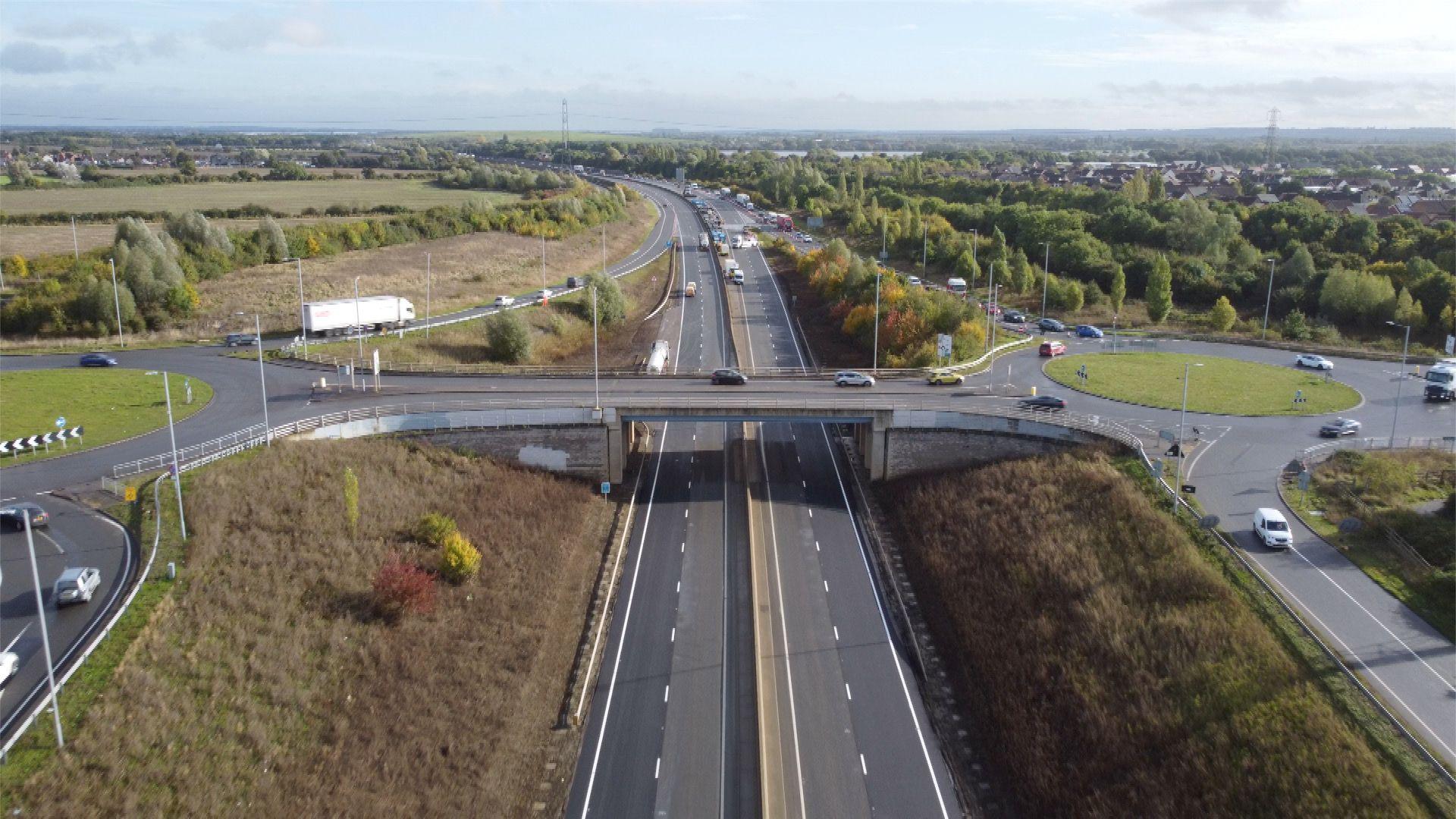 An ariel view of the A421. The road is closed so has no traffic but it is clear of water. Other surrounding roads are busier.