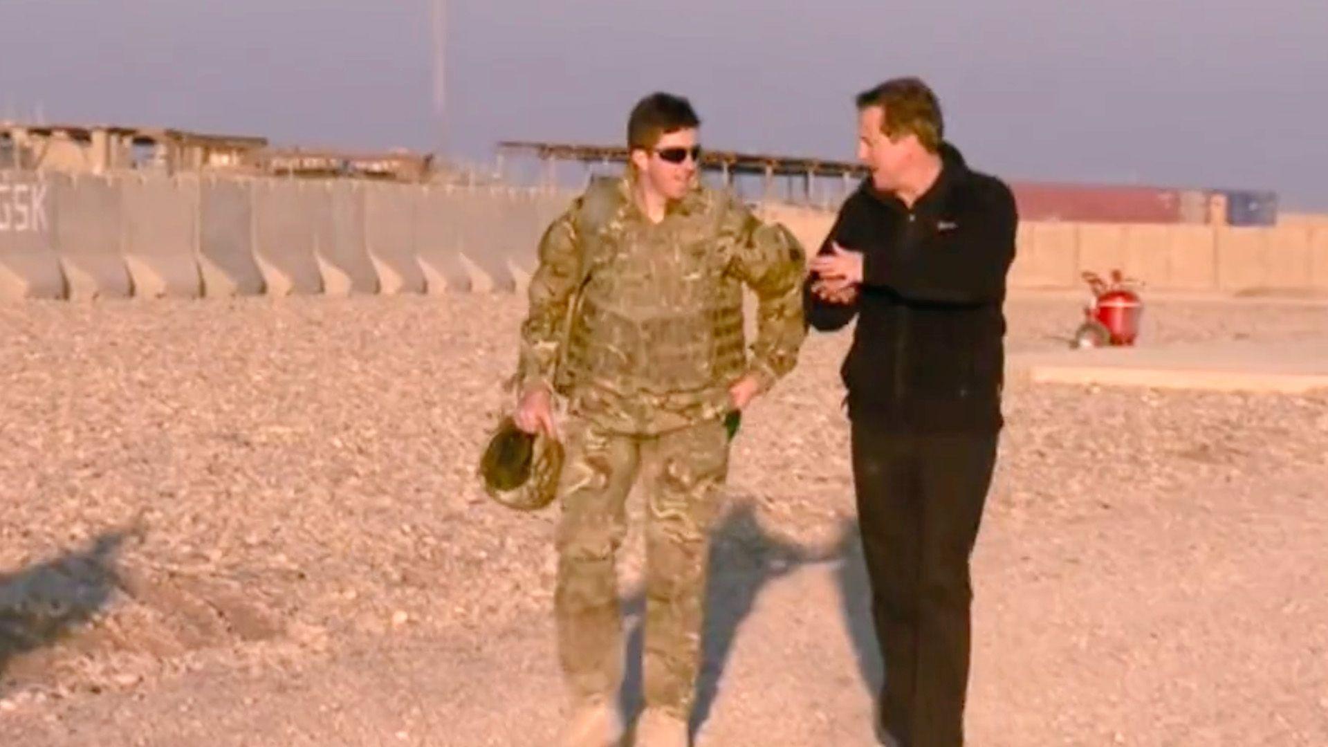 Gen Jenkins and David Cameron walk and talk in Afghanistan.
