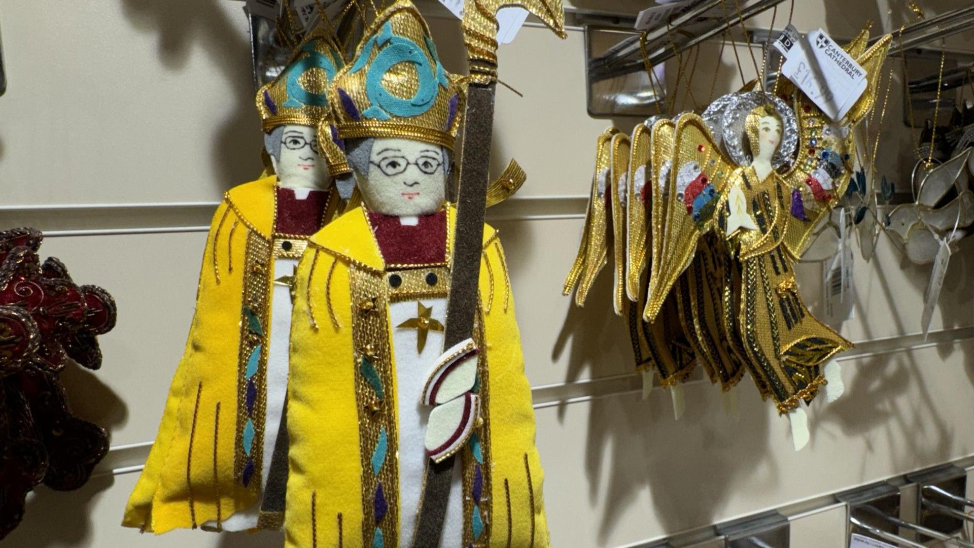 An Justin Welby Archbishop of Canterbury and angel Christmas tree decoration hanging in a shop.