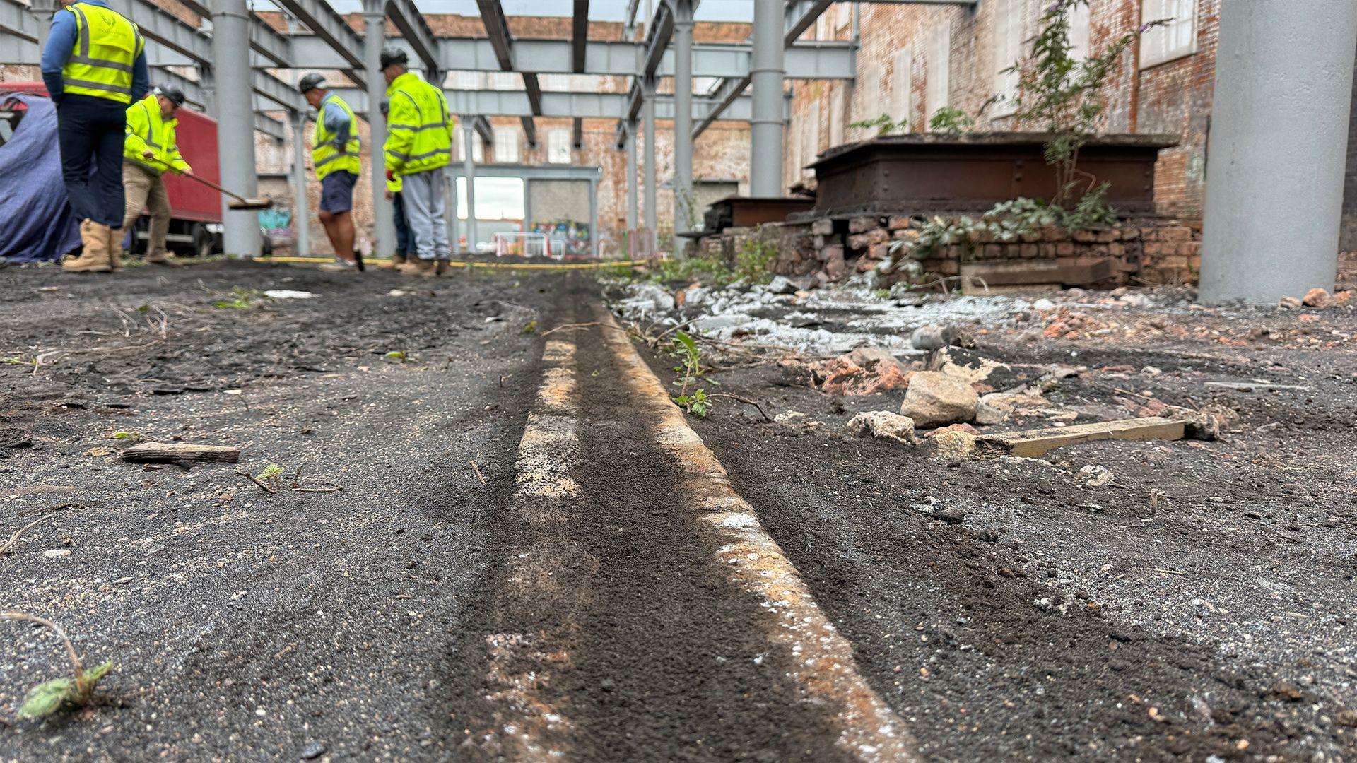 Inside the Grade II-listed bonded warehouse at the Friar Gate Goods Yard in Derby, showing original railway tracks for the Great Northern Railway.