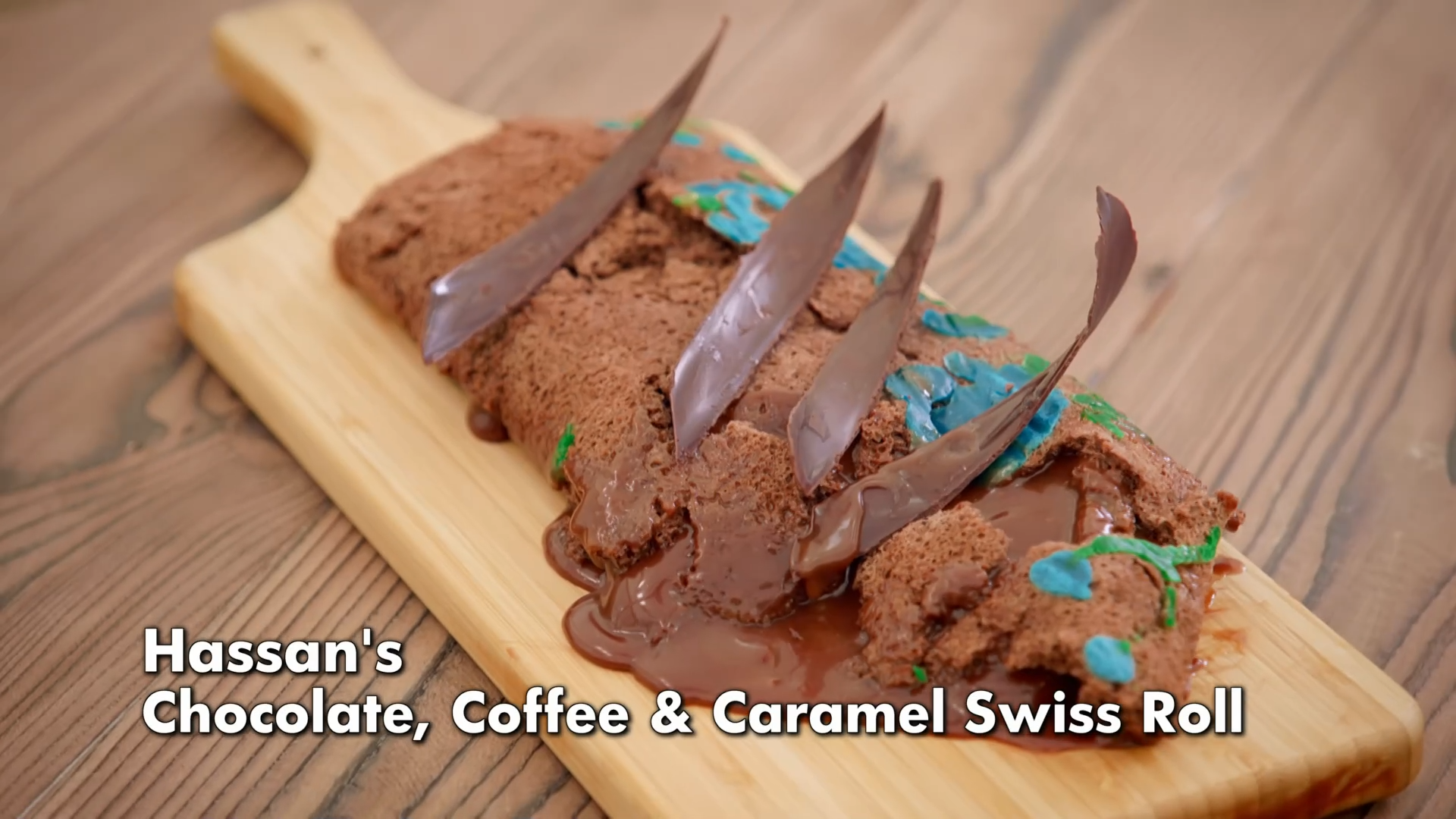 Hassan's chocolate, coffee, and caramel Swiss roll. It has fallen apart, with caramel pooling underneath the flat and crumbled cake.