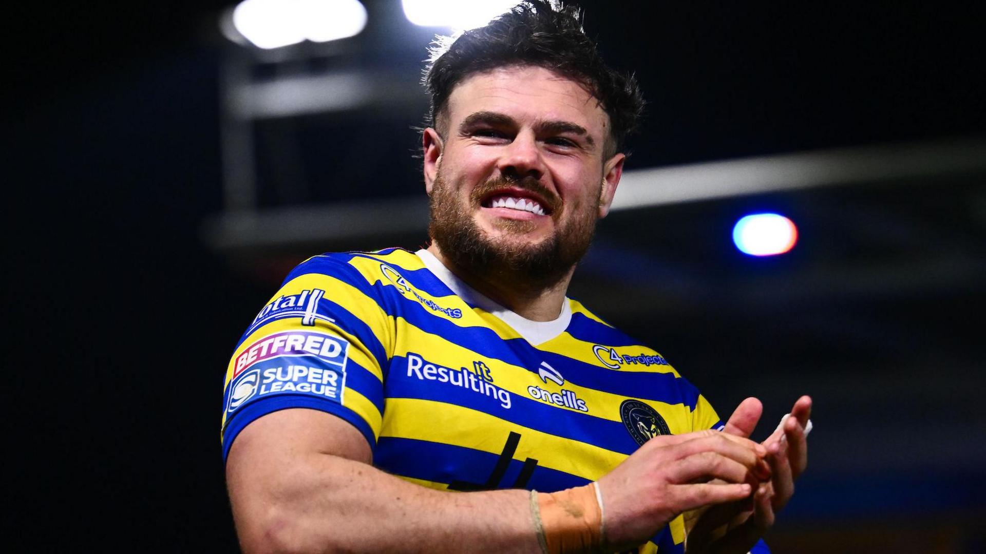 Joe Philbin applauds the fans after a game wearing Warrington's yellow and blue striped home jersey