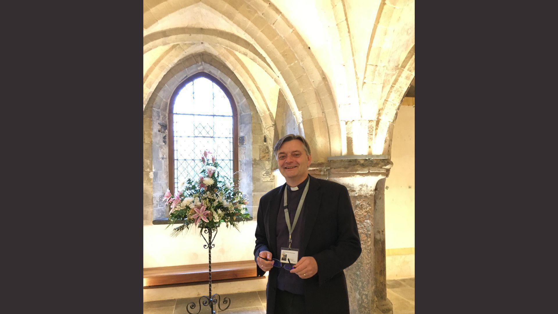 The Very Reverend Philip Hasketh standing inside Rochester Cathedral.