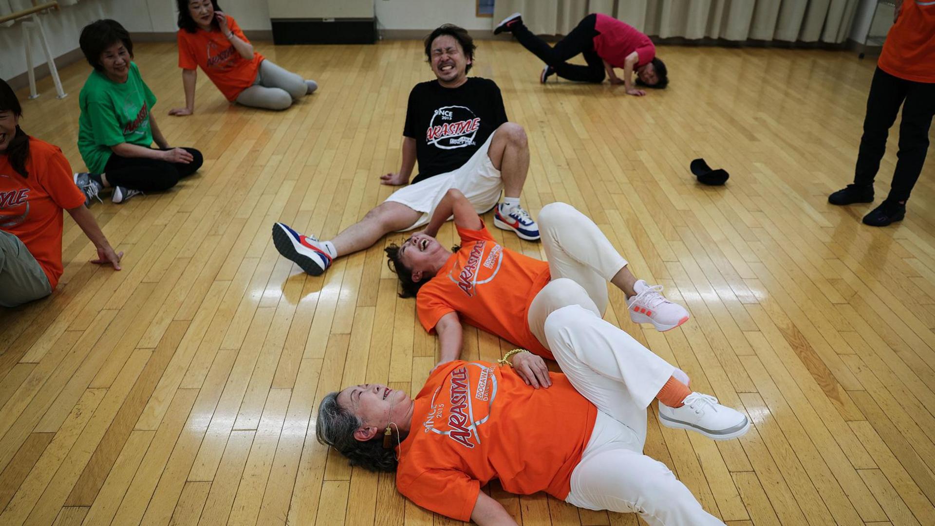 elderly breakdancers, laughing