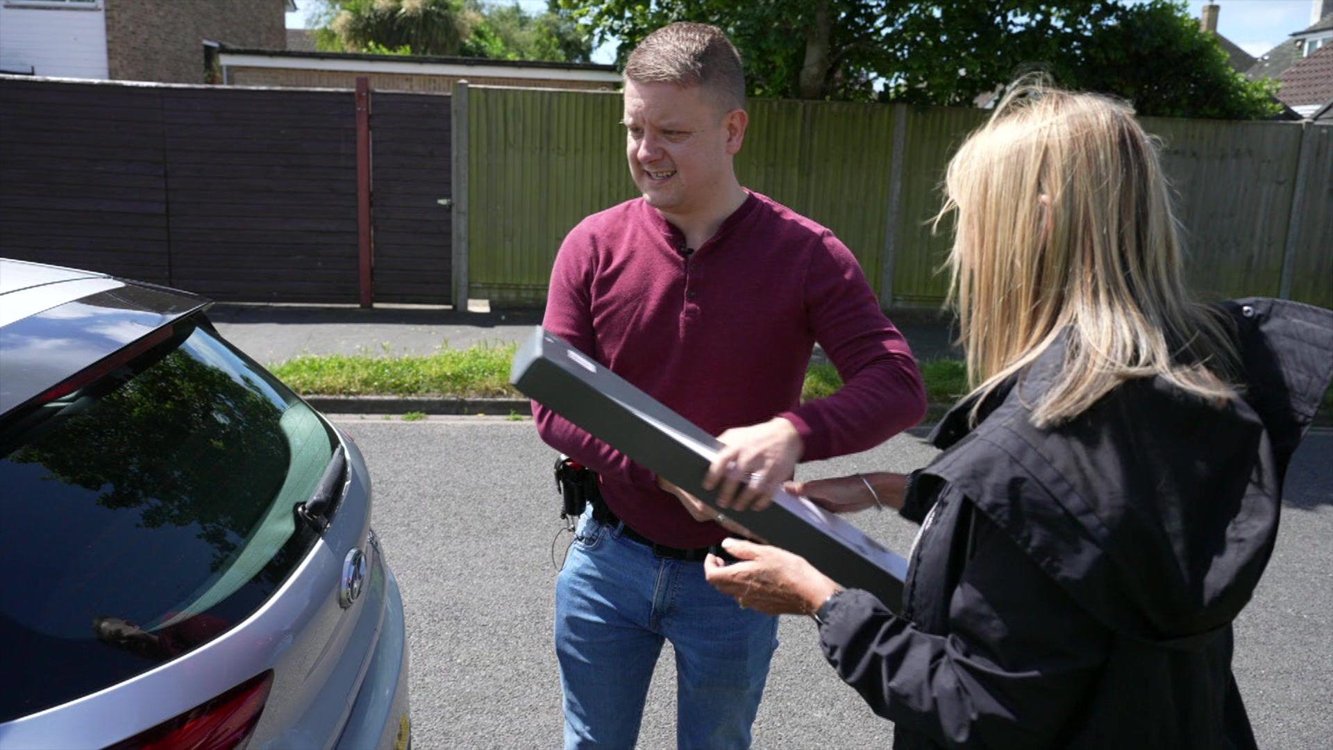 A Sussex Police office and an Independent Domestic Violence Advisor on a home visit