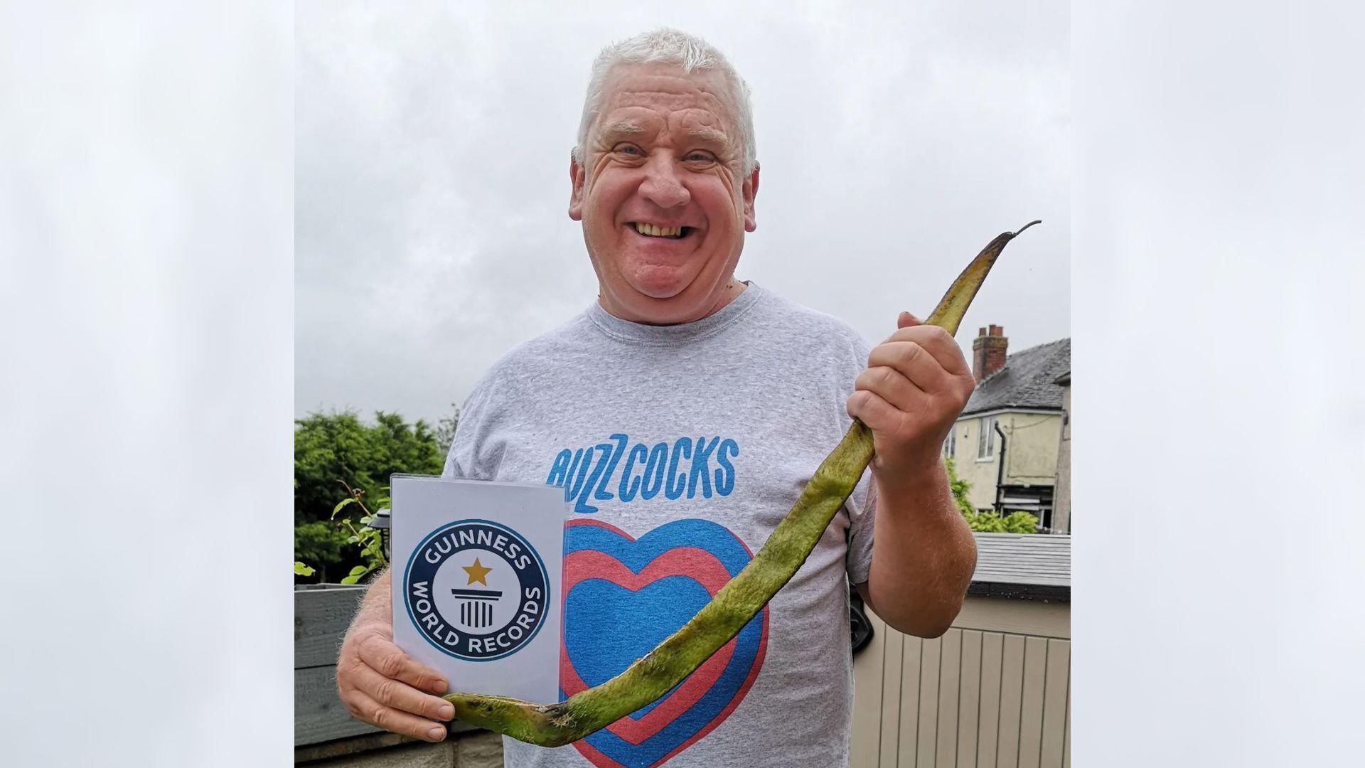 Derek Hulme holds his award-winning runner bean.