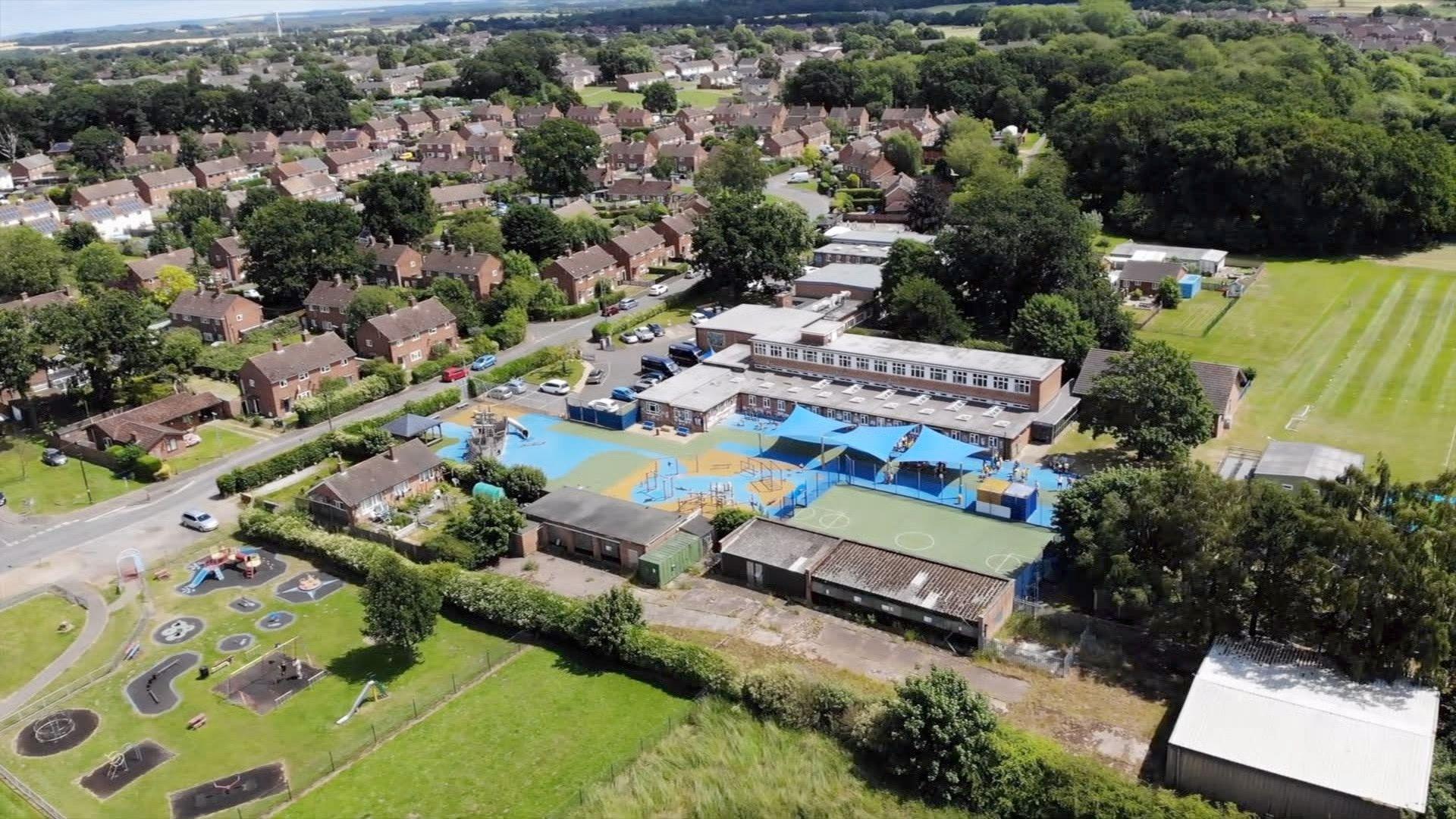 An aerial shot of the Howard Junior School, showing a number of buildings and playing fields