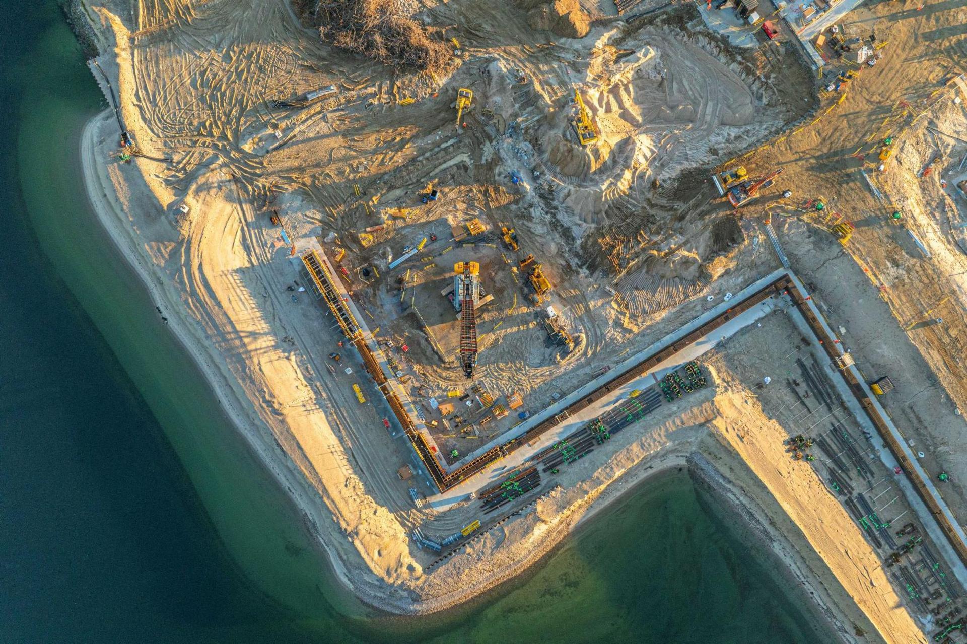 An aerial view of part of the yard at Ardersier. A crane is working in a sandy landscape on the shores of the Moray Firth.