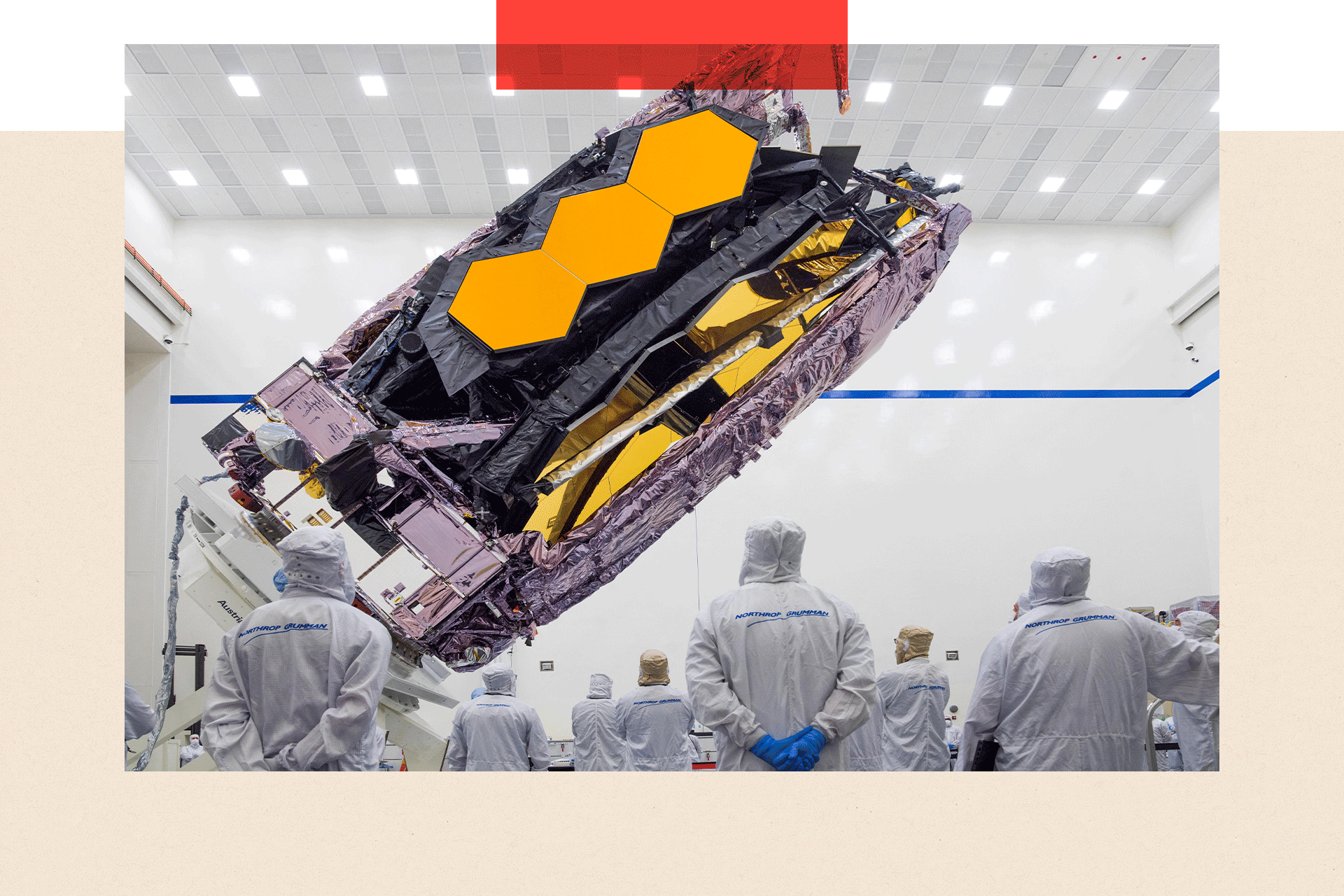The James Webb Space Telescope is packed up for shipment, as people look on
