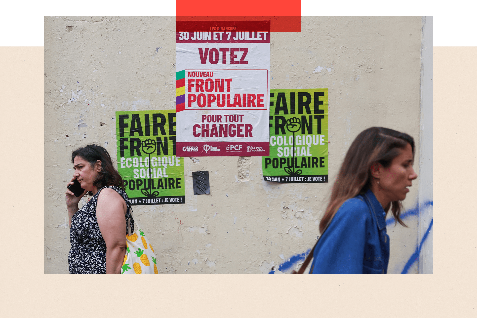 Two pedestrians walk past election posters for the Nouveau Front Populaire (New Popular Front) in Paris, ahead of the second round of France's legislative elections