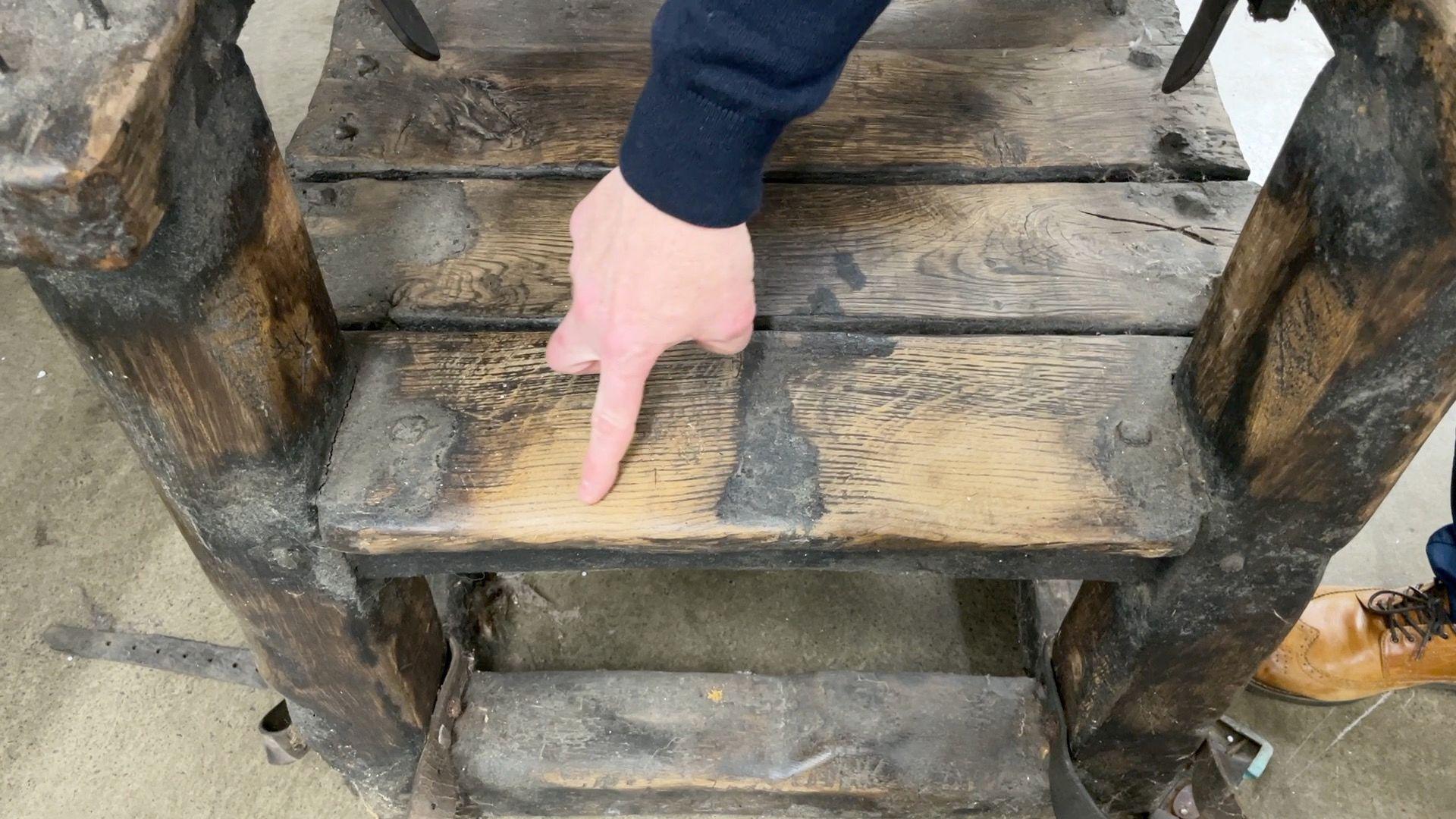 Richard Griza pointing to the wear on one of the seats